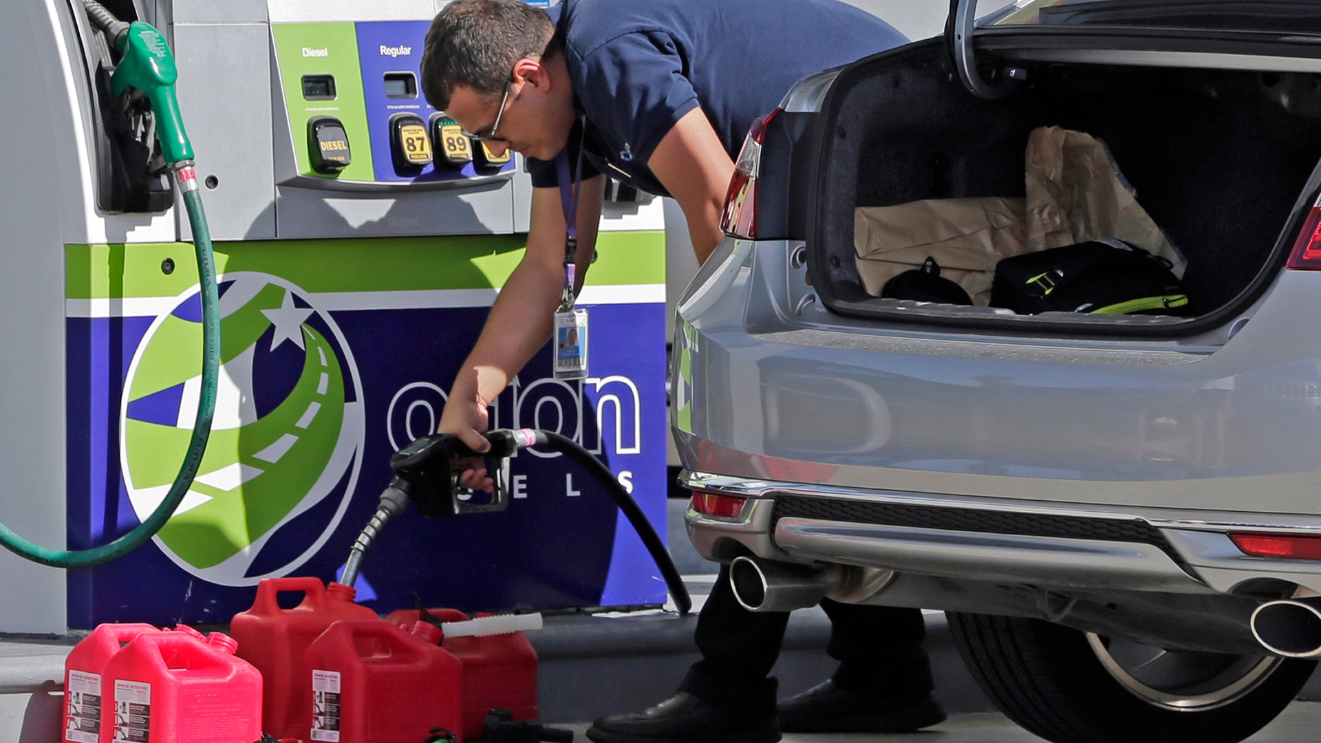 A motorist fills up containers with gas as he prepares for Hurricane Irma, Thursday