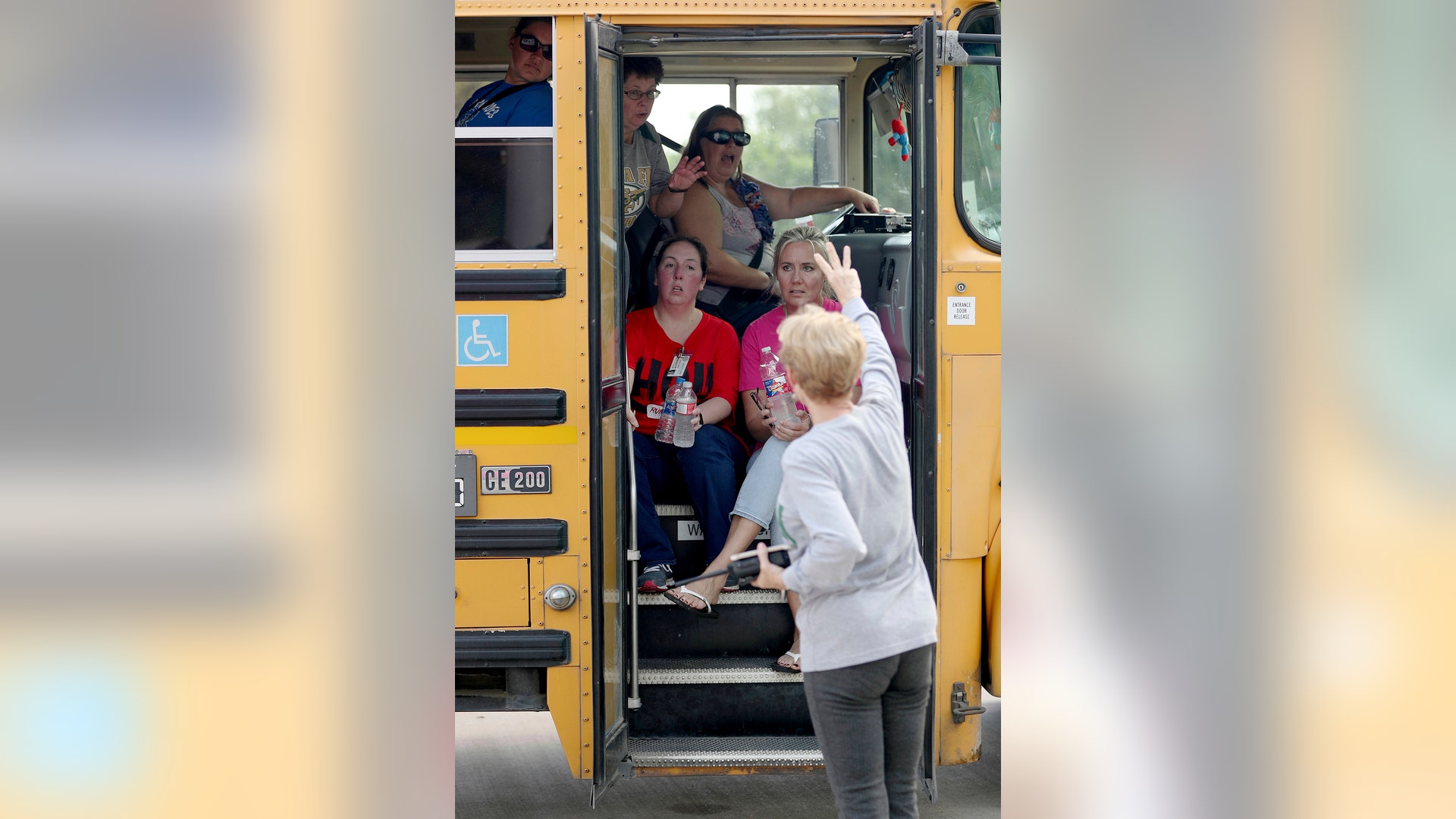 School staff members sit in a school bus after a shooting at the Santa Fe High School in Santa Fe, Texas, May 18, 2018