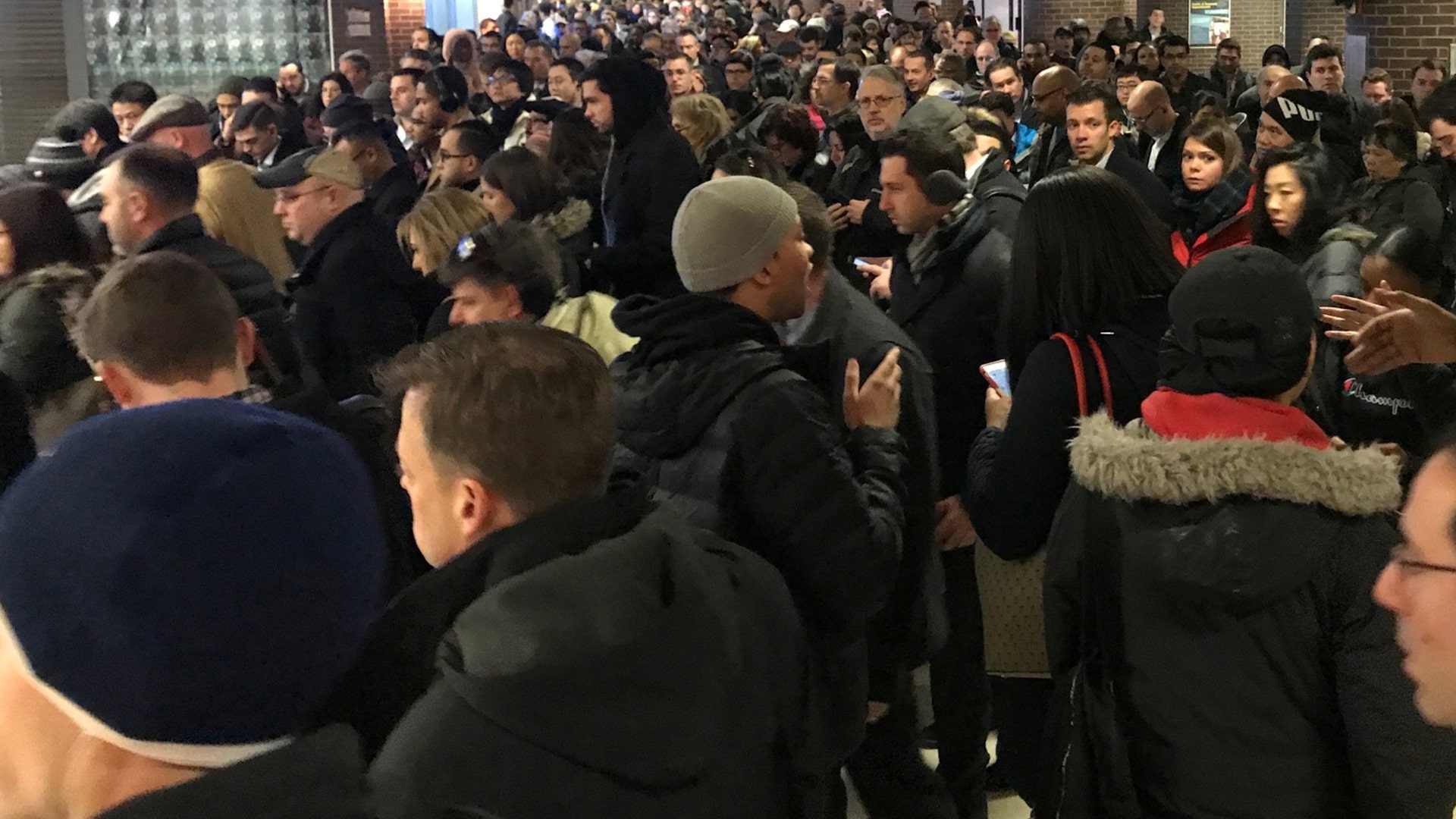 Commuters exit the New York Port Authority after an explosion in New York City, Monday