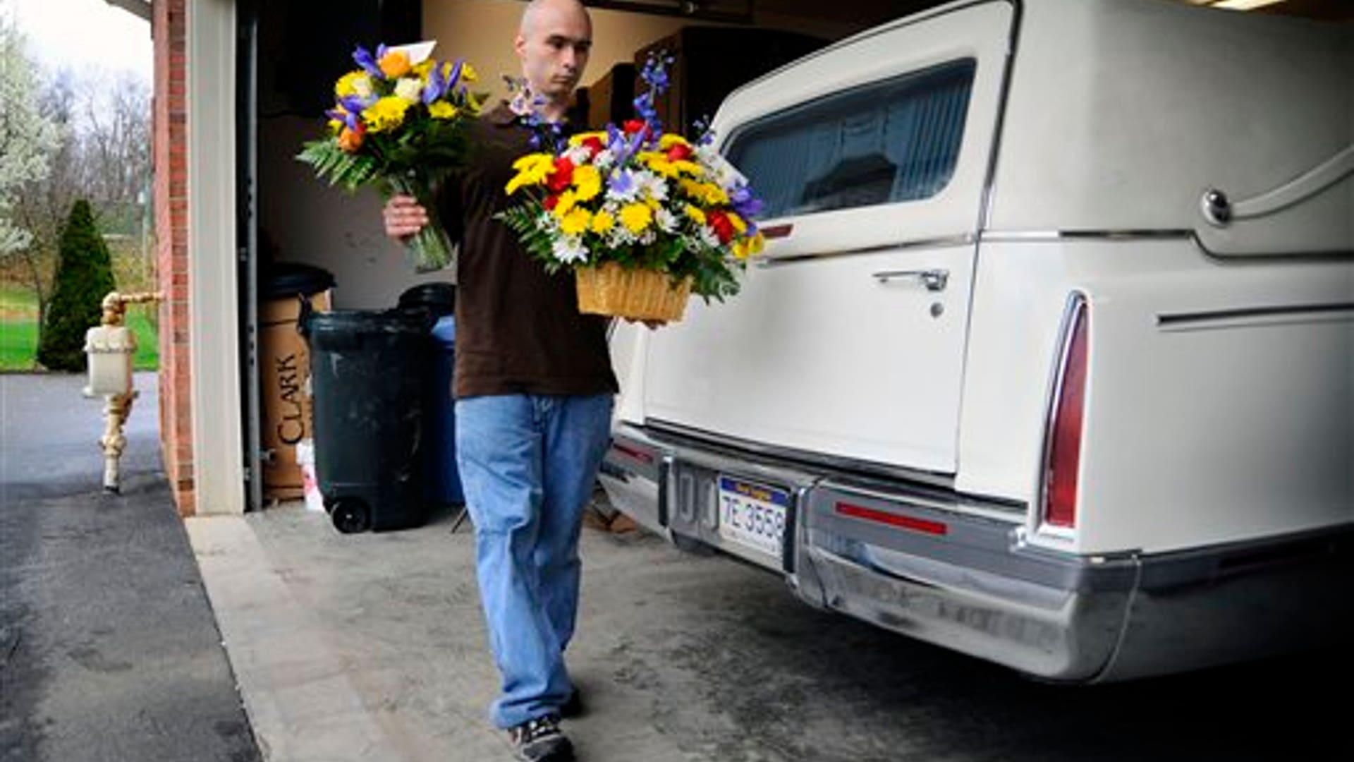 Man brings flowers to deceased coal miner