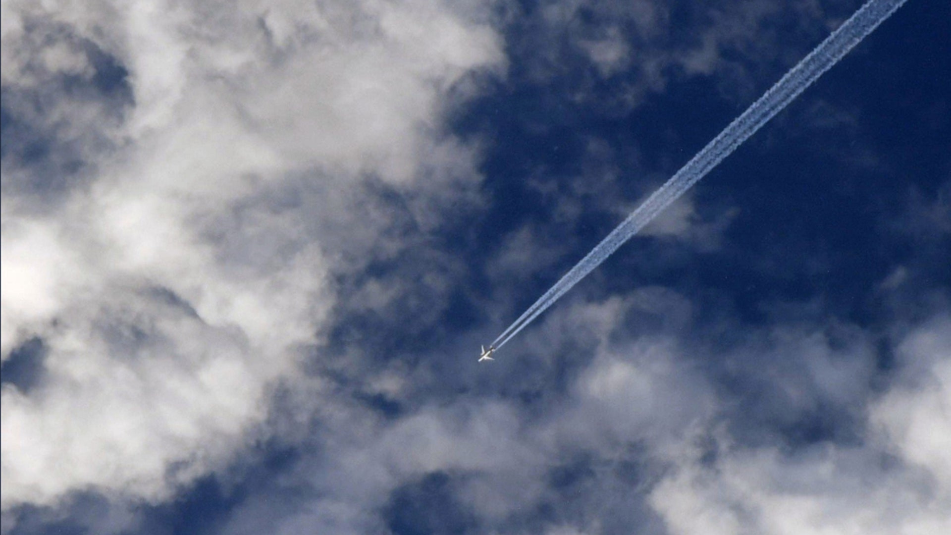 A airplane flies over Hawaii's Kilauea volcano seen from the International Space Station on May 13, 2018