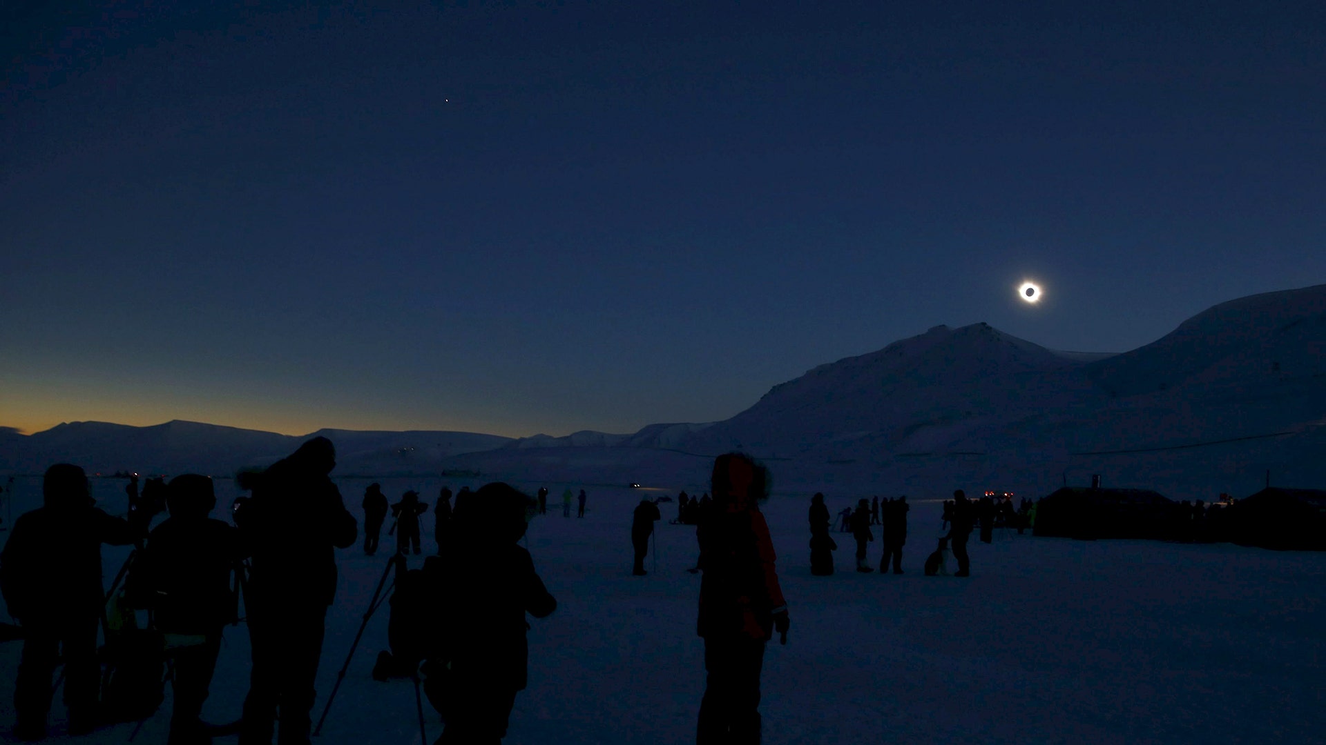 People look at a total solar eclipse on Svalbard, Norway, March 20, 2015