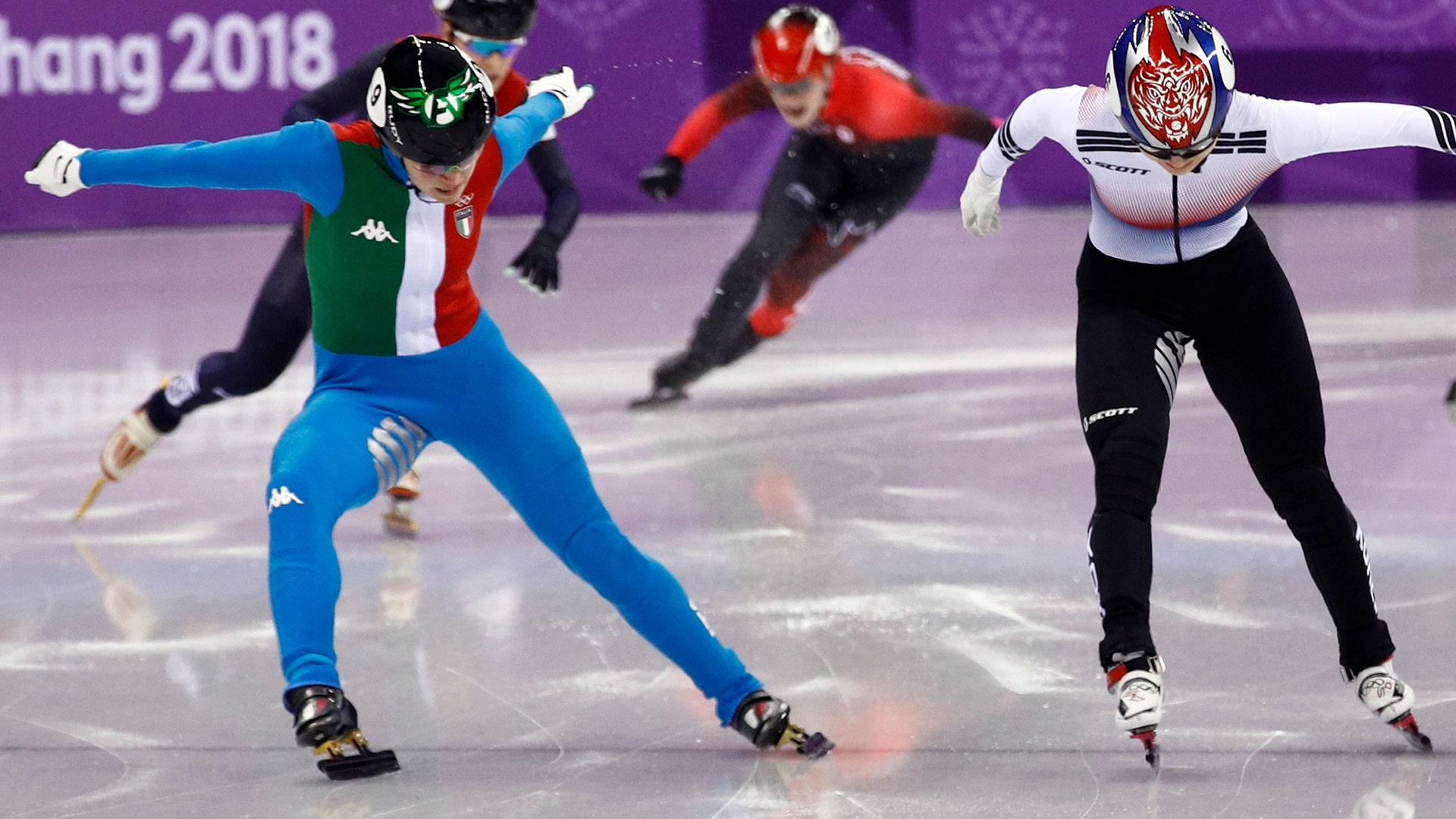 Arianna Fontana, left, of Italy crosses the finish line to win the ladies' 500 meters short track speedskating final at the 2018 Winter Olympics
