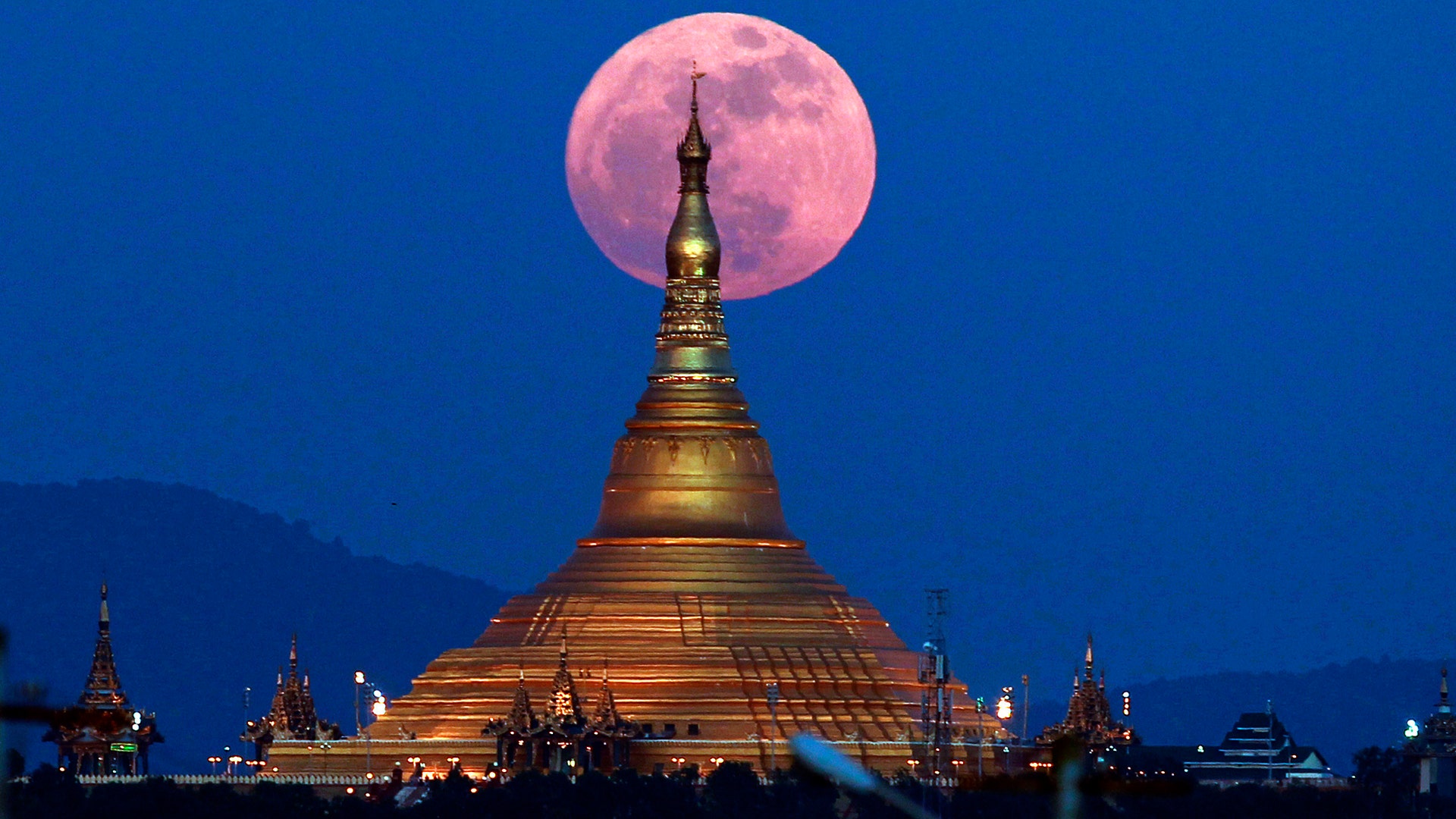 The moon rises behind the Uppatasanti Pagoda seen in Naypyitaw, Myanmar, December 3