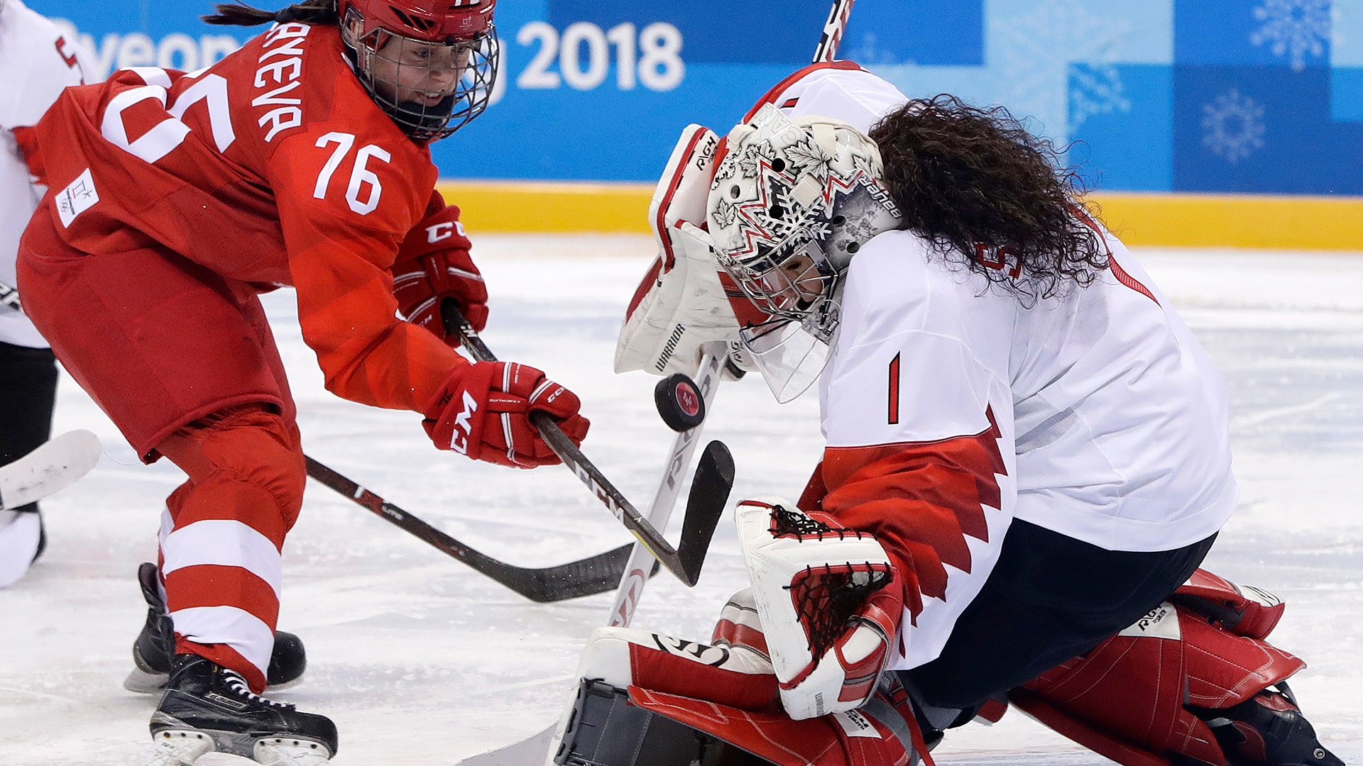 Goalie Shannon Szabados of Canada, deflects a shot by Russian Yekaterina Nikolayeva in their ice hockey game  at the 2018 Winter Olympics