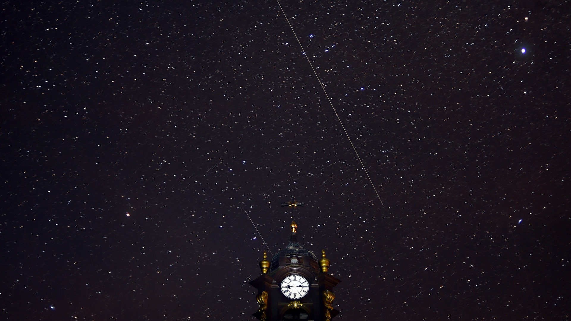 Perseids meteors cross the night sky over a Catholic church in the village of Vowchyn, Belarus, August 12, 2018