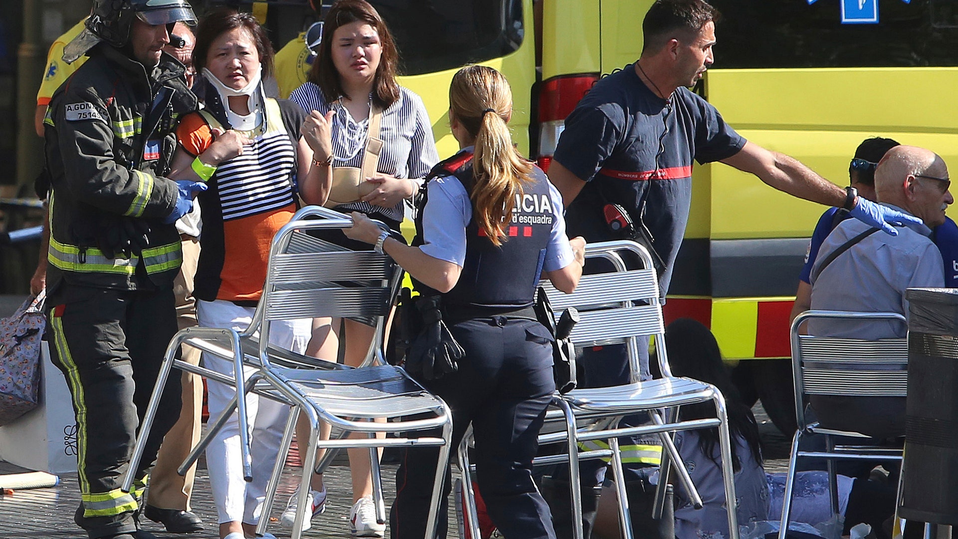 People are helped after a van crashed into a crowd of residents and tourists on Las Ramblas in Barcelona, August 17