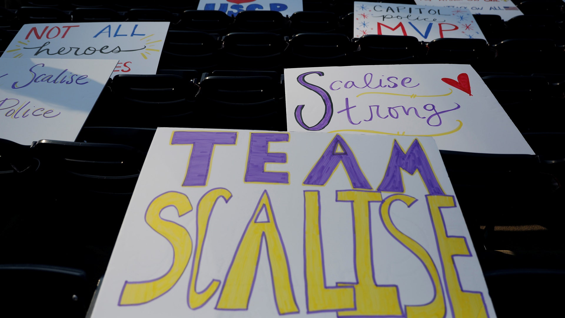 Signs acknowledging wounded congressman Rep. Steve Scalise are seen prior to the Congressional baseball game 