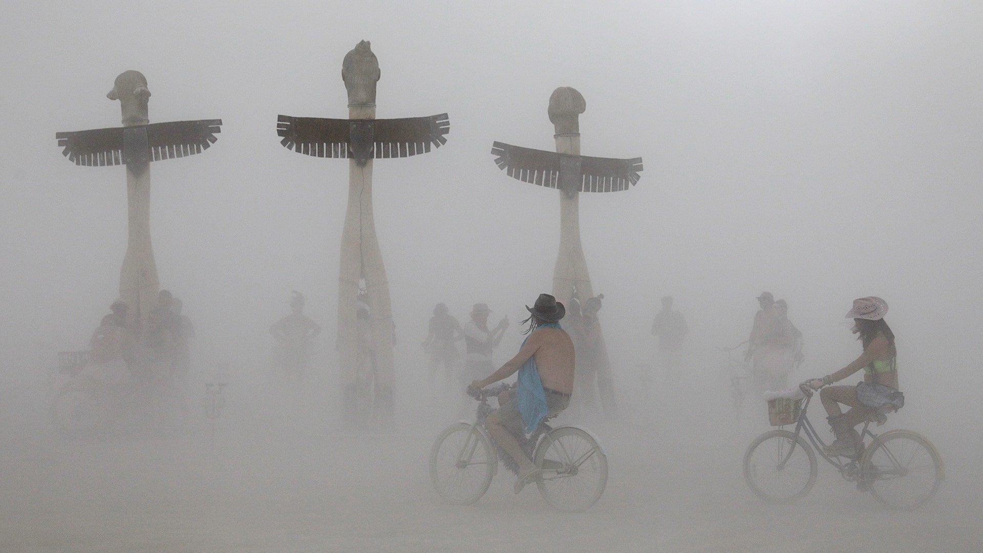 Participants bicycle past the 