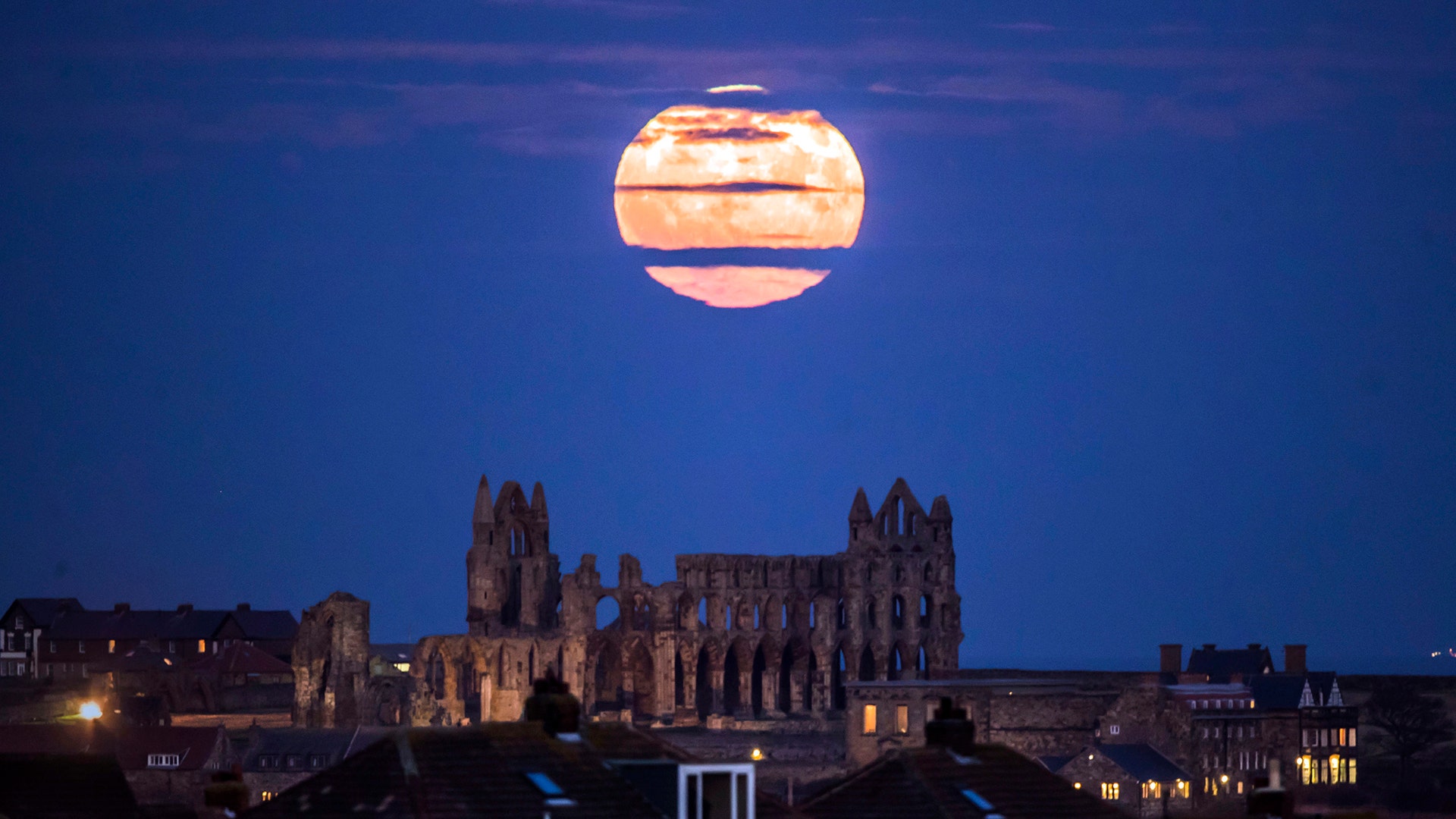 The moon rises above Whitby Abbey in Whitby, north east England, December 3