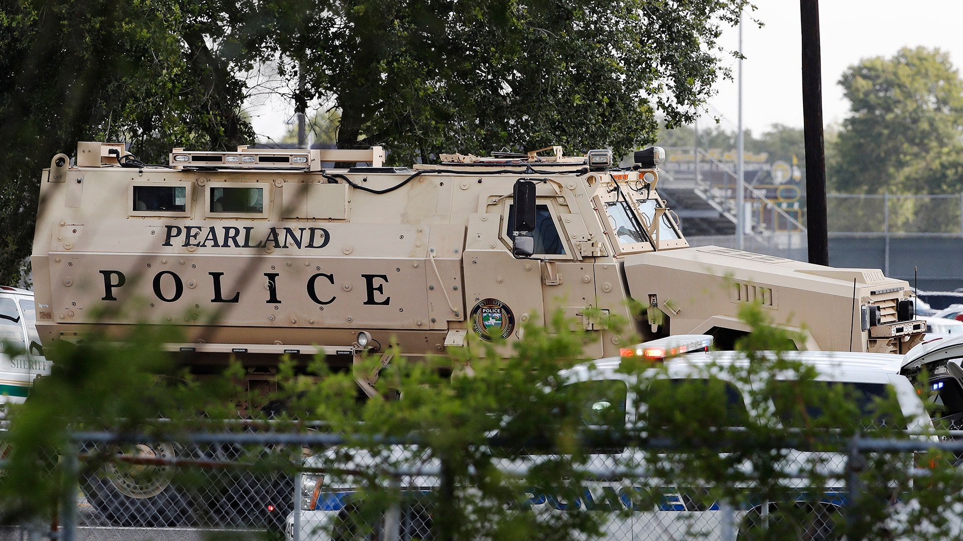 A Pearland Police armored vehicle stands ready in front of Santa Fe High School in Santa Fe, Texas, in response to a shooting, May 18, 2018