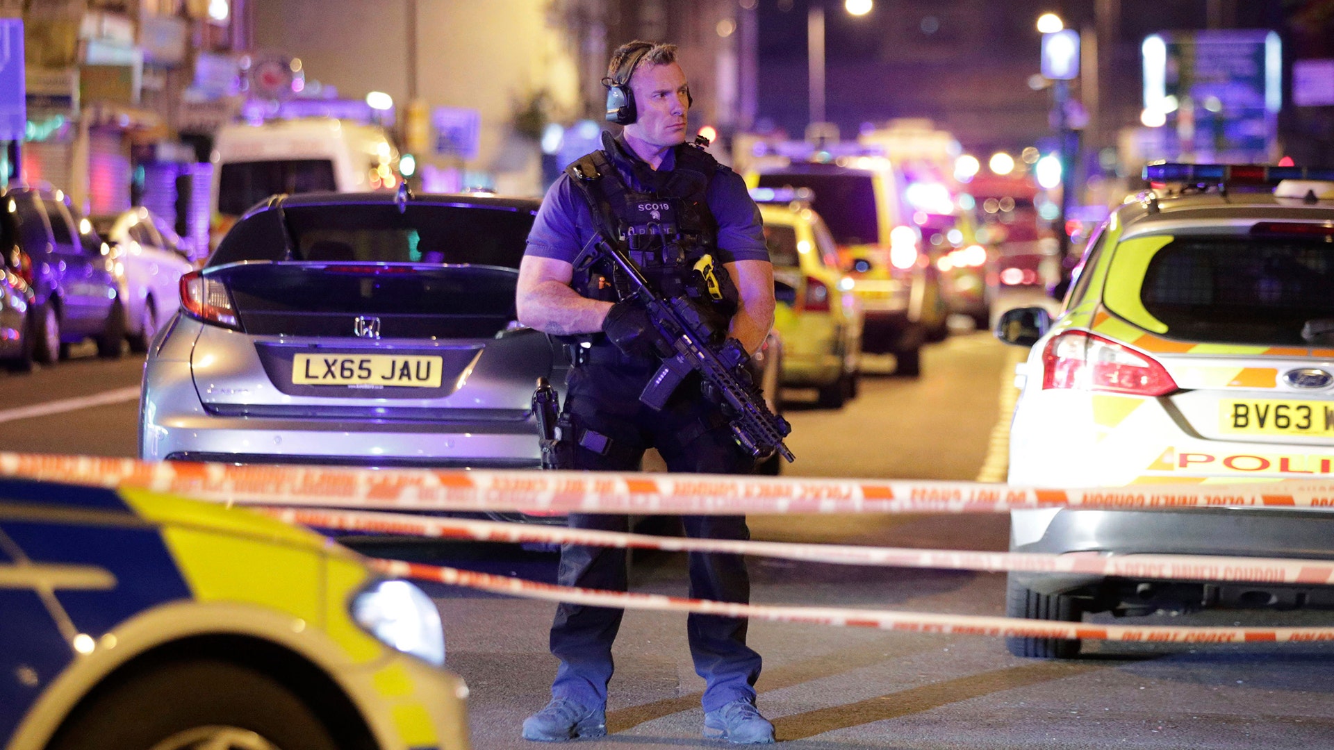 An armed police officer mans a cordon on the Seven Sisters Road at Finsbury Park where a vehicle struck pedestrians in London