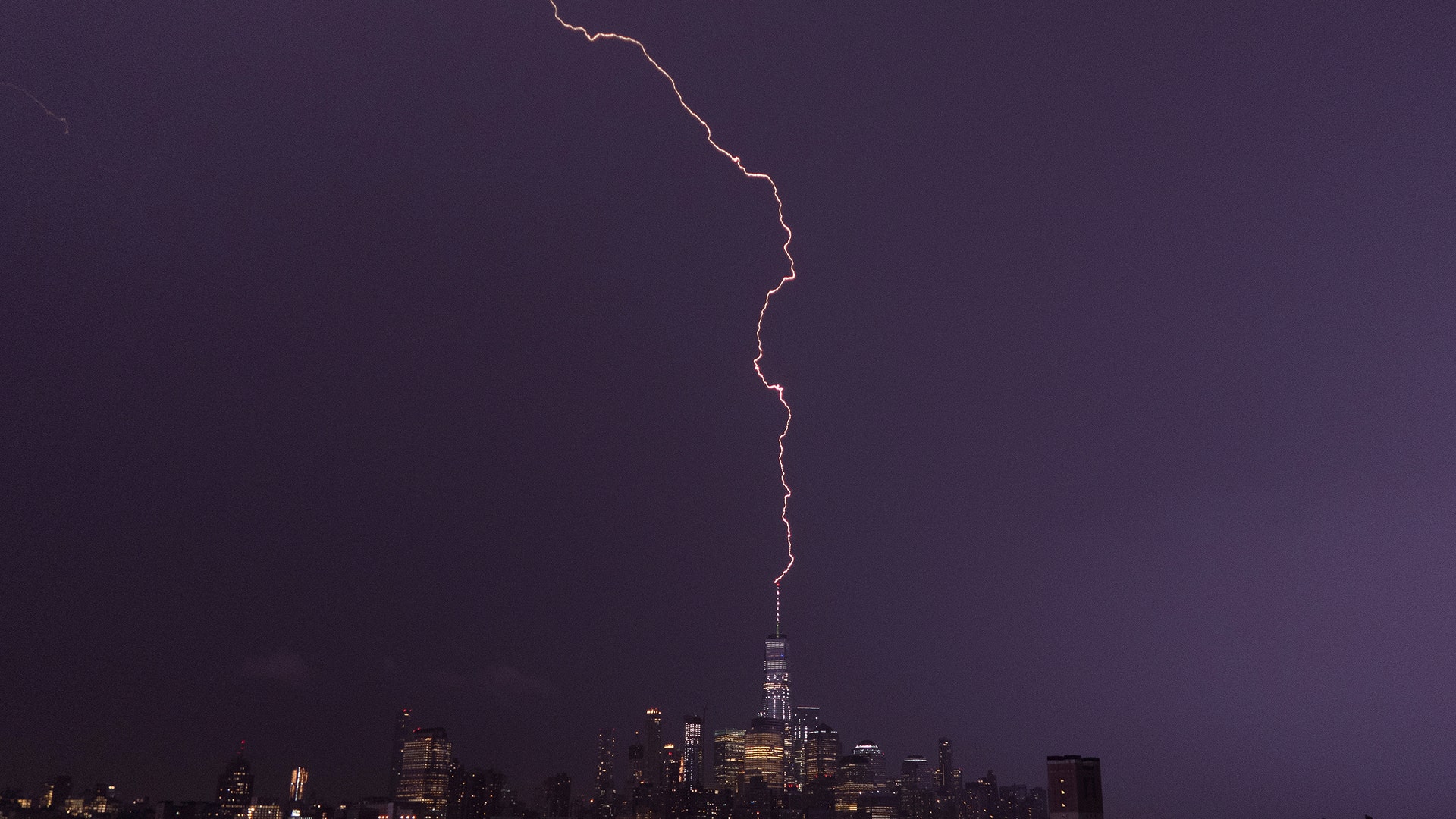 A single bolt of lightning strikes One World Trade Center