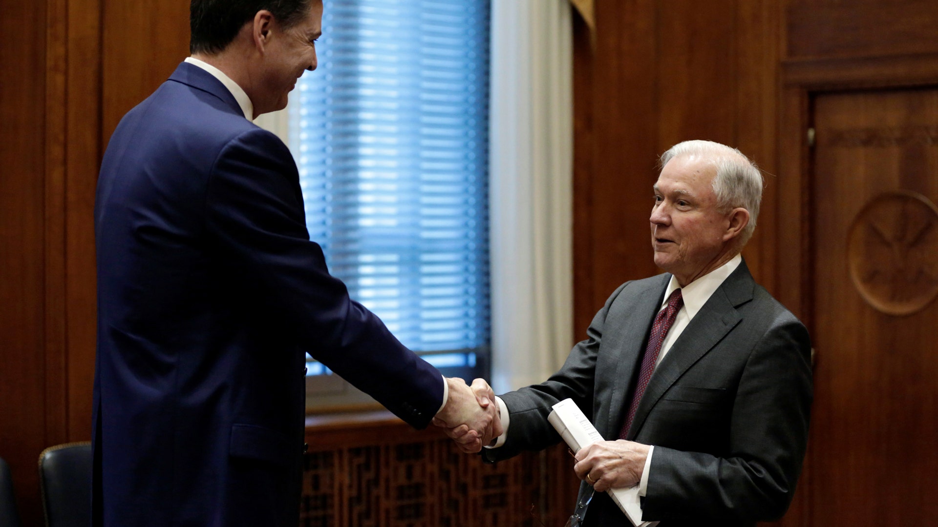 U.S. Attorney General Jeff Sessions shakes hands with FBI Director James Comey at the Justice Department, February 9, 2017