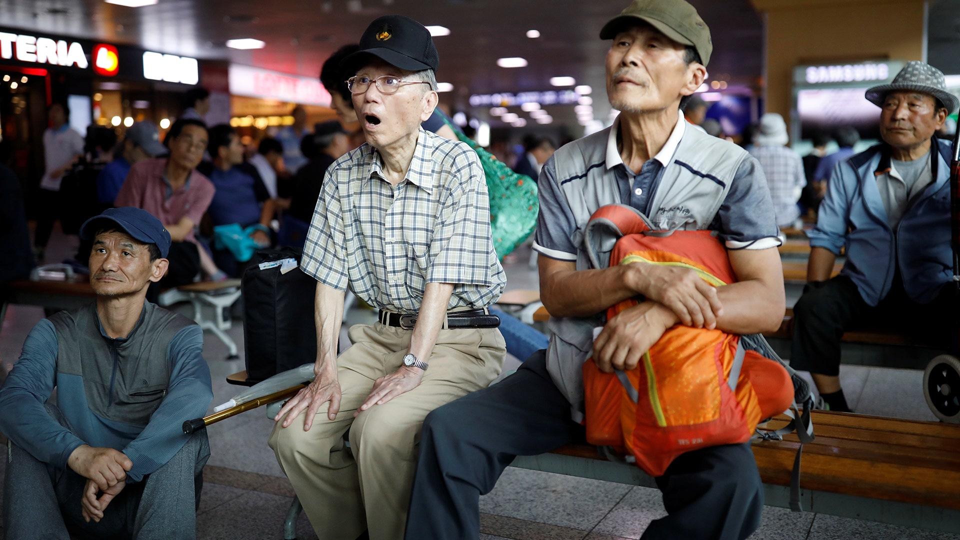 People watch a TV broadcast of a news report on North Korea's Hwasong-14 missile at a railway station in Seoul, South Korea, July 4