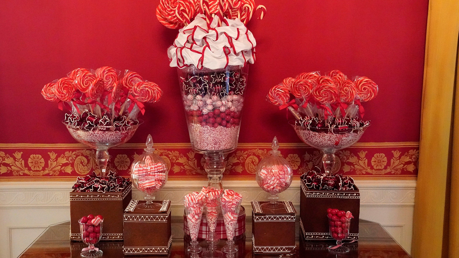Christmas decor adorns the Red Room of the White House.