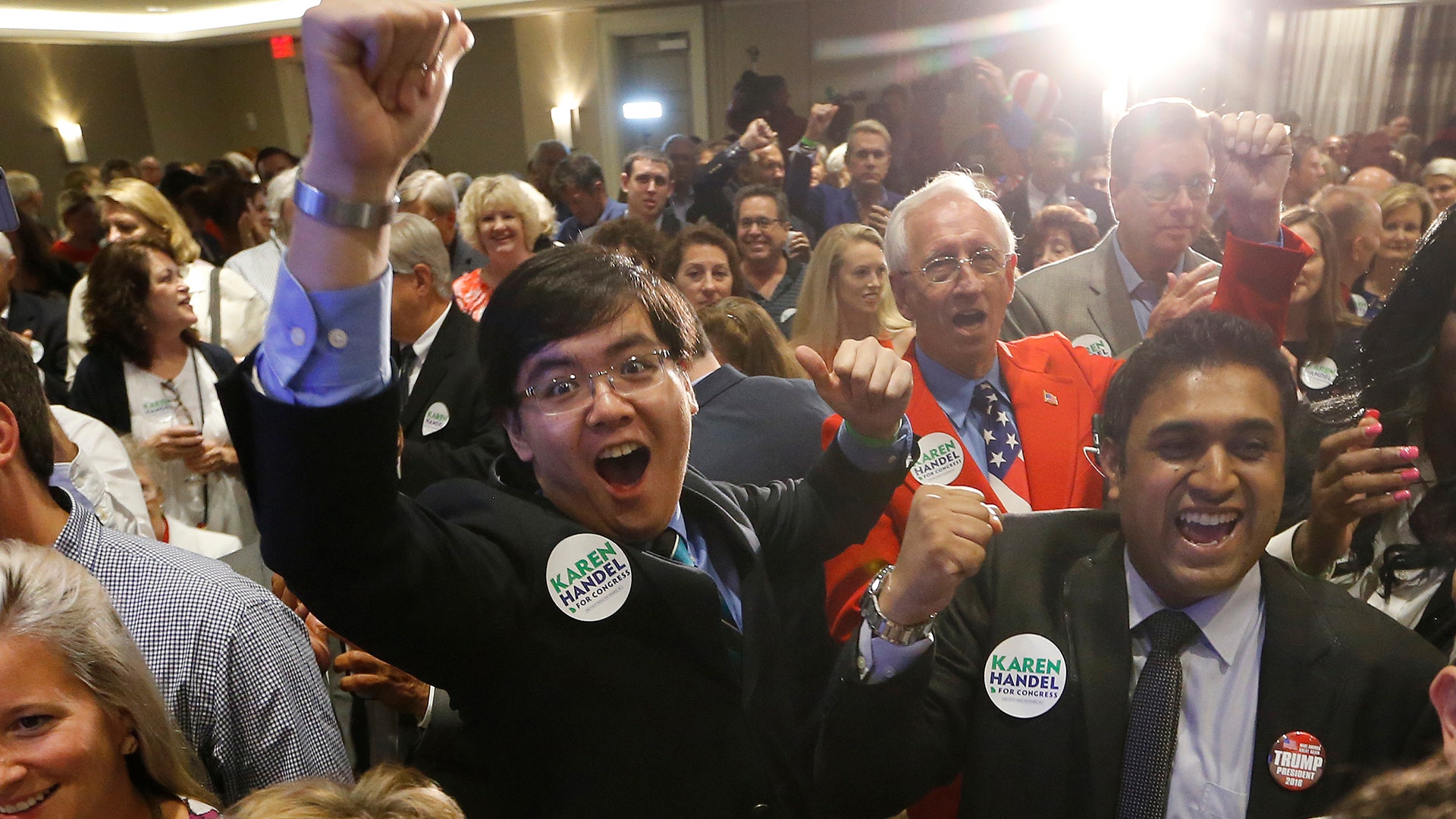 Supporters react as election results for Republican candidate for Georgia's 6th Congressional District seat Karen Handel are shown