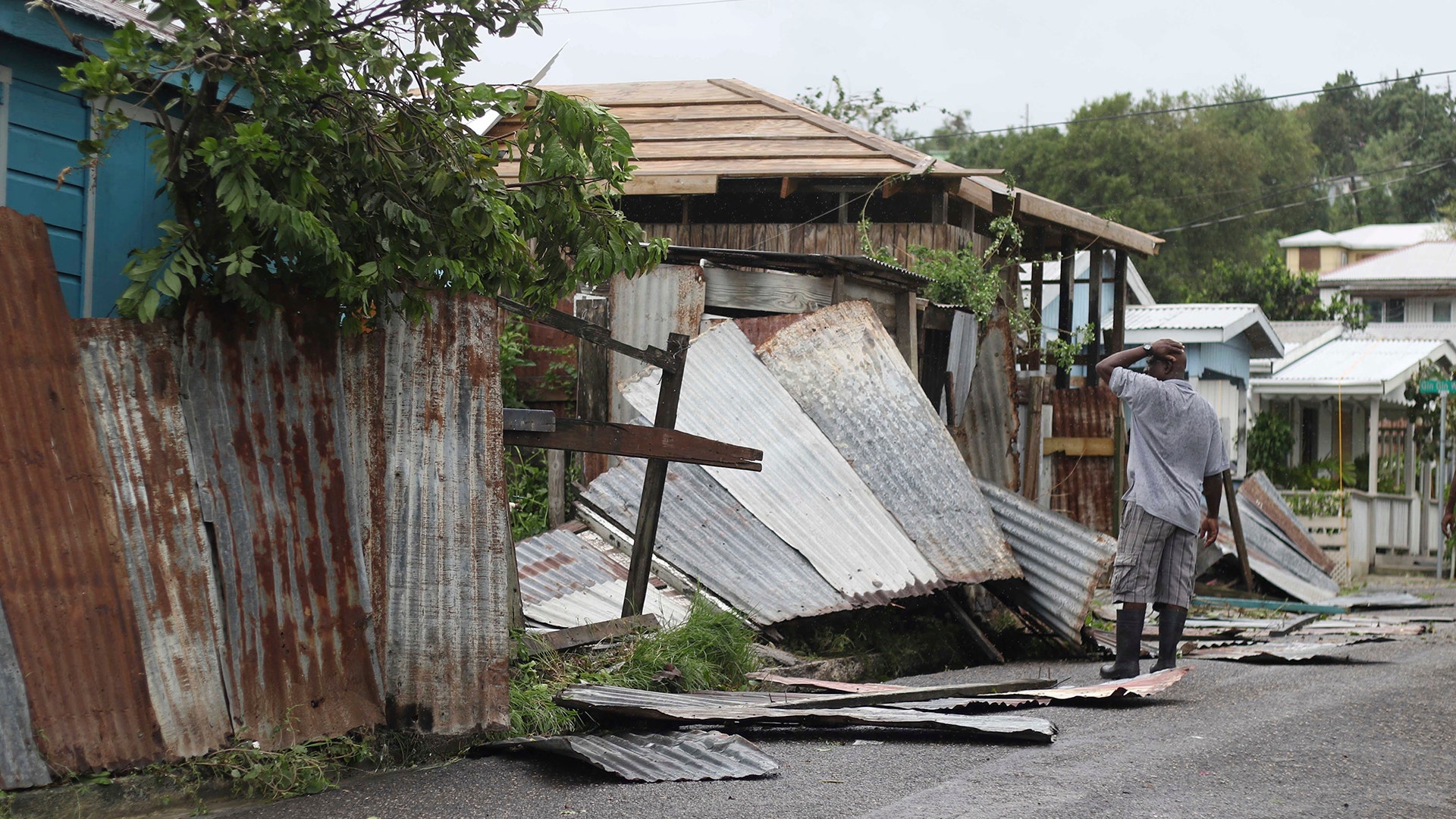 A man surveys the wreckage on his property after the passing of Hurricane Irma, in St. John's, Antigua and Barbuda, Wednesday