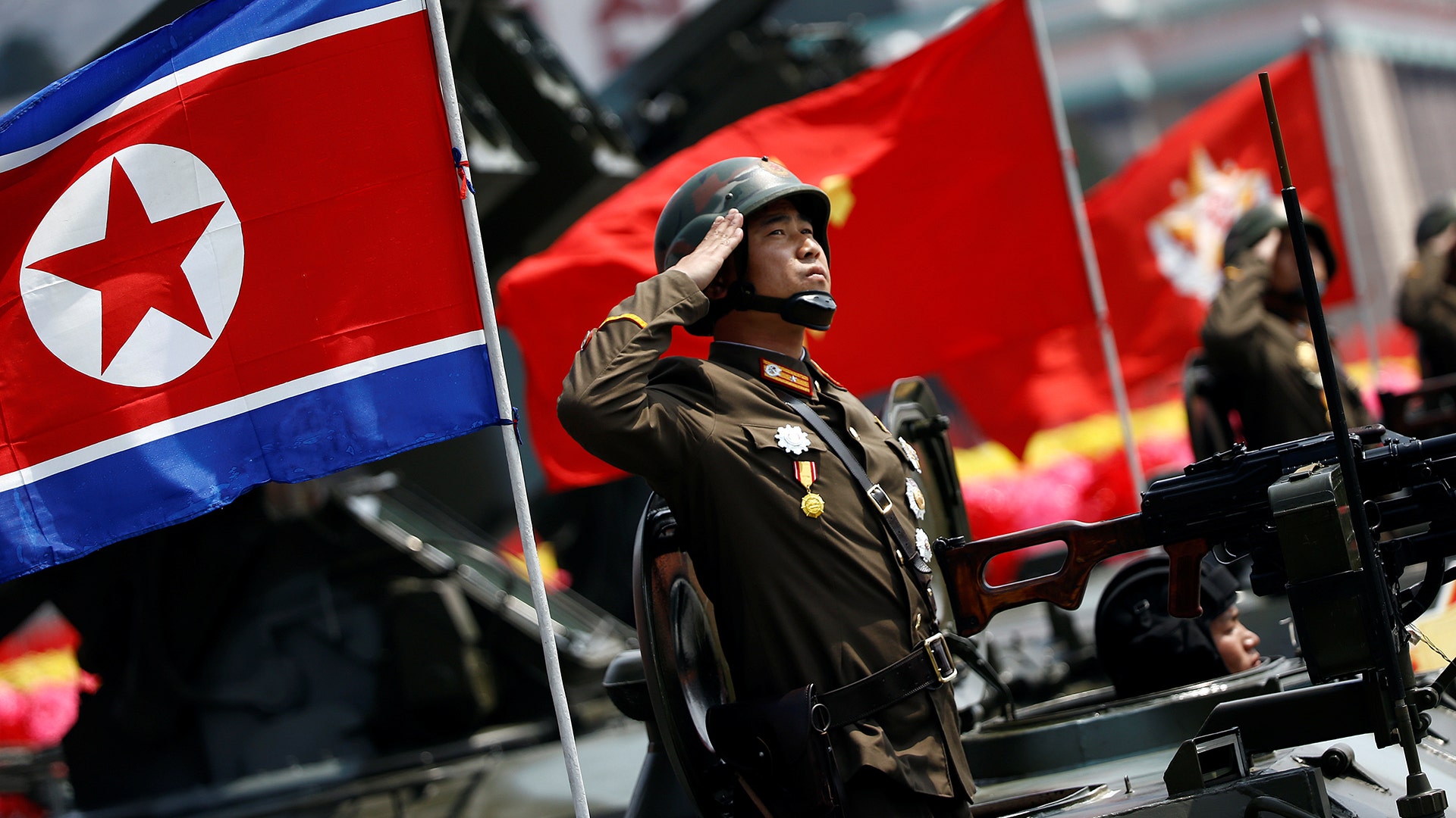 A soldier salutes from atop an armored vehicle during a military parade in Pyongyang April 15, 2017