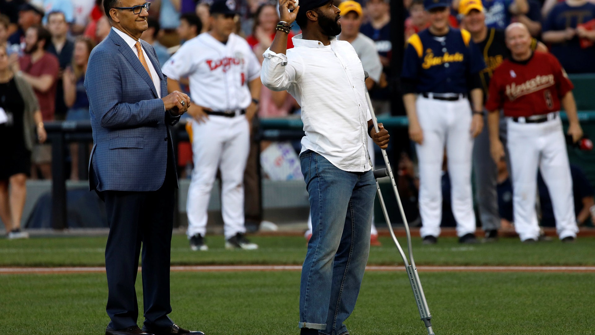 Special Agent David Bailey of the U.S. Capitol Police, wounded in Wednesday's attack with Joe Torre, as he throws out the first pitch