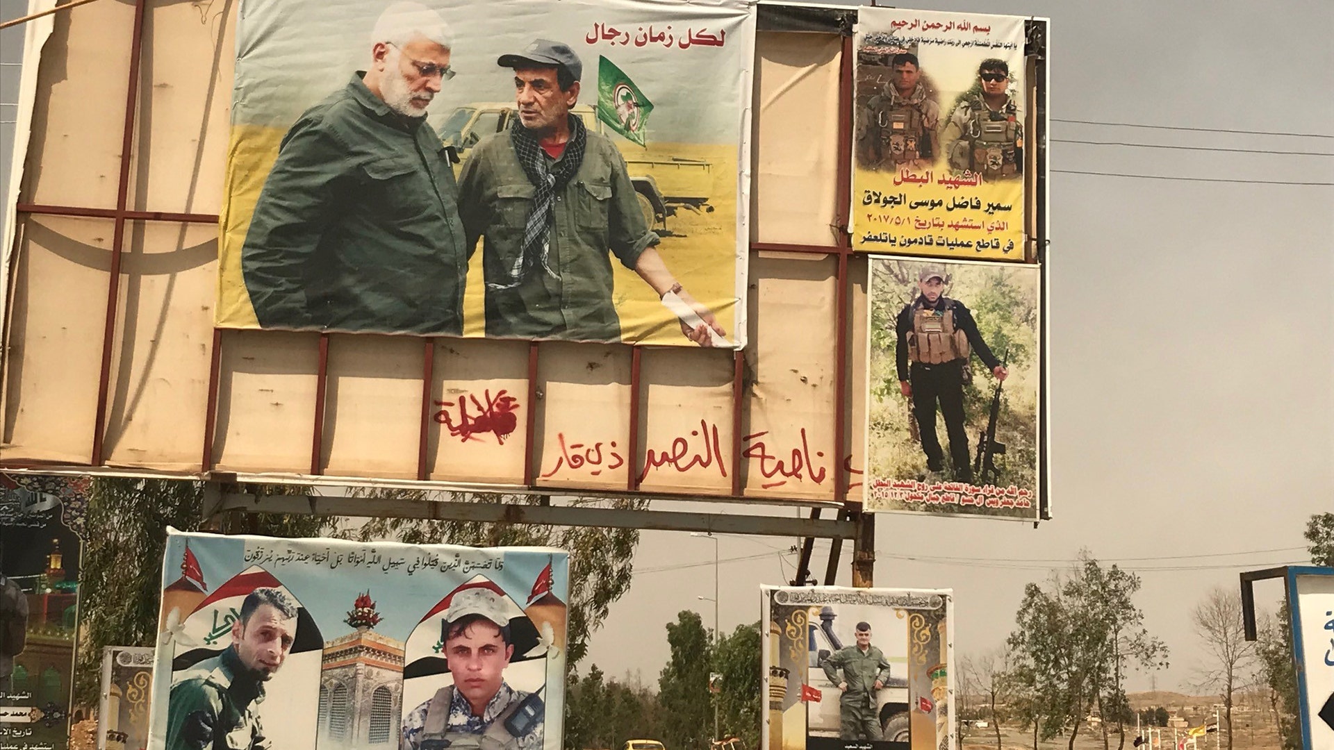Large campaign posters for an upcoming election are all over Tel Afar, where election activities have slowed recovery efforts