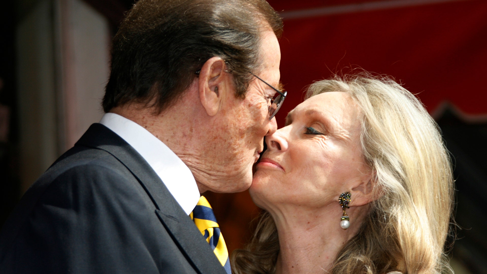 Moore kisses his wife Kristina during ceremonies unveiling his star on the Hollywood Walk of Fame on October 11, 2007