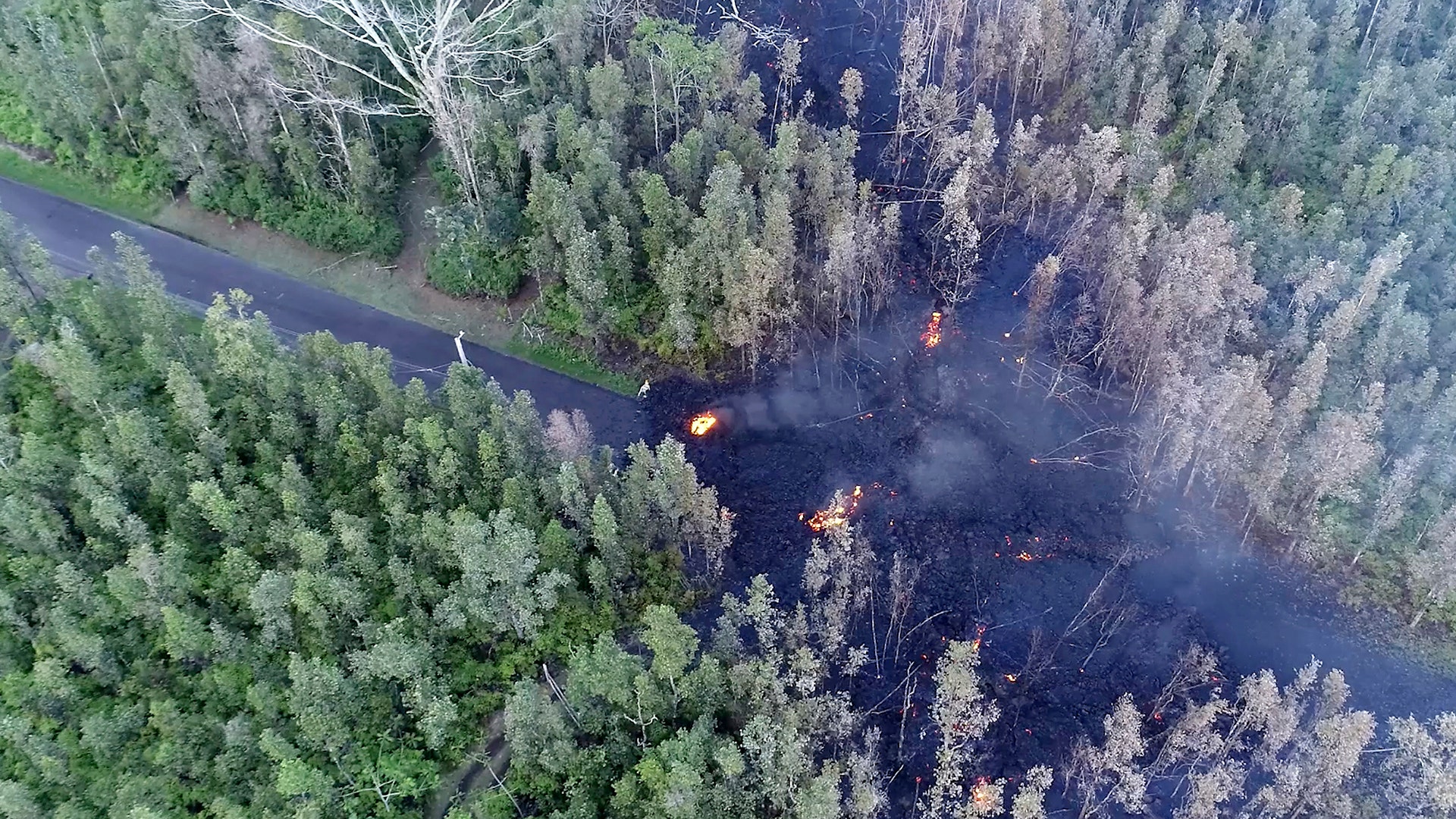 Lava flows over a road in the Puna District as a result of the eruption from Kilauea Volcano on Hawaii's Big Island, May 4, 2018