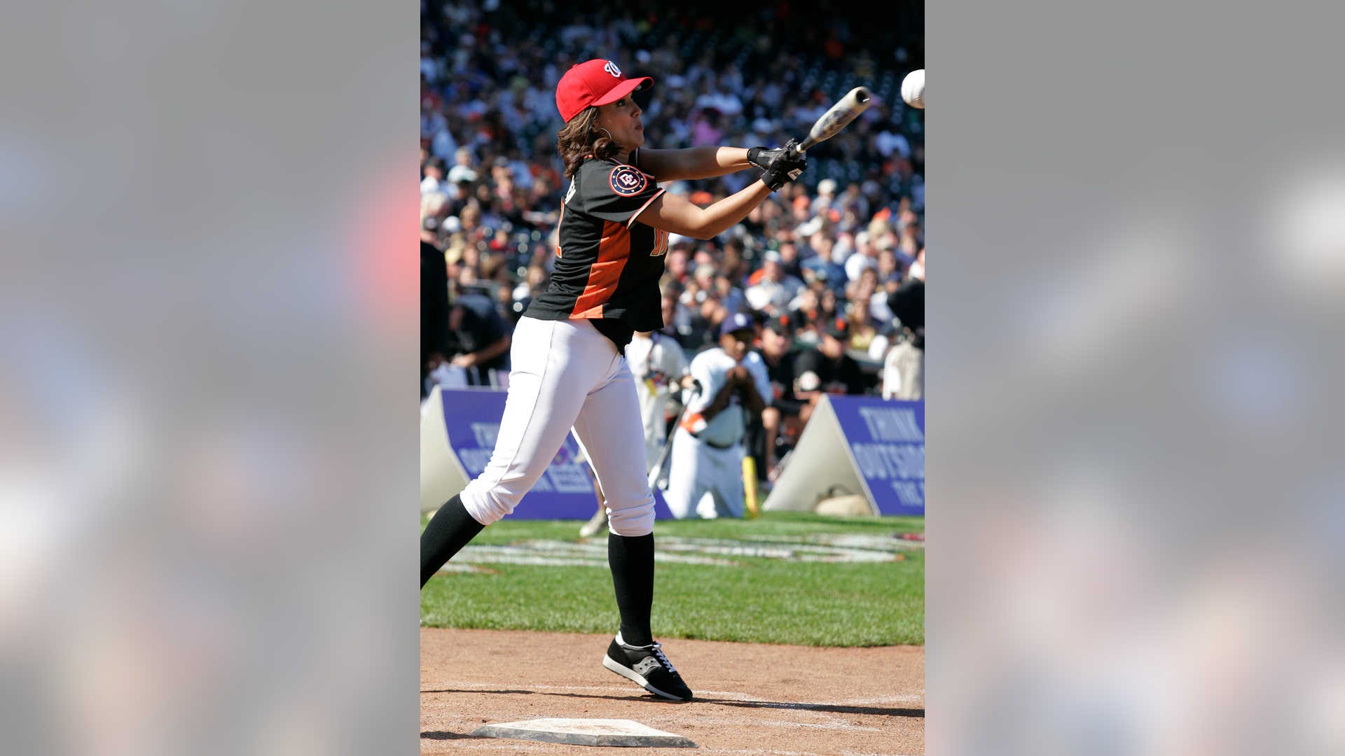 Model Leeann Tweeden hits a ground out during the All Star Legends & Celebrity Softball Game in San Francisco, July 8, 2007