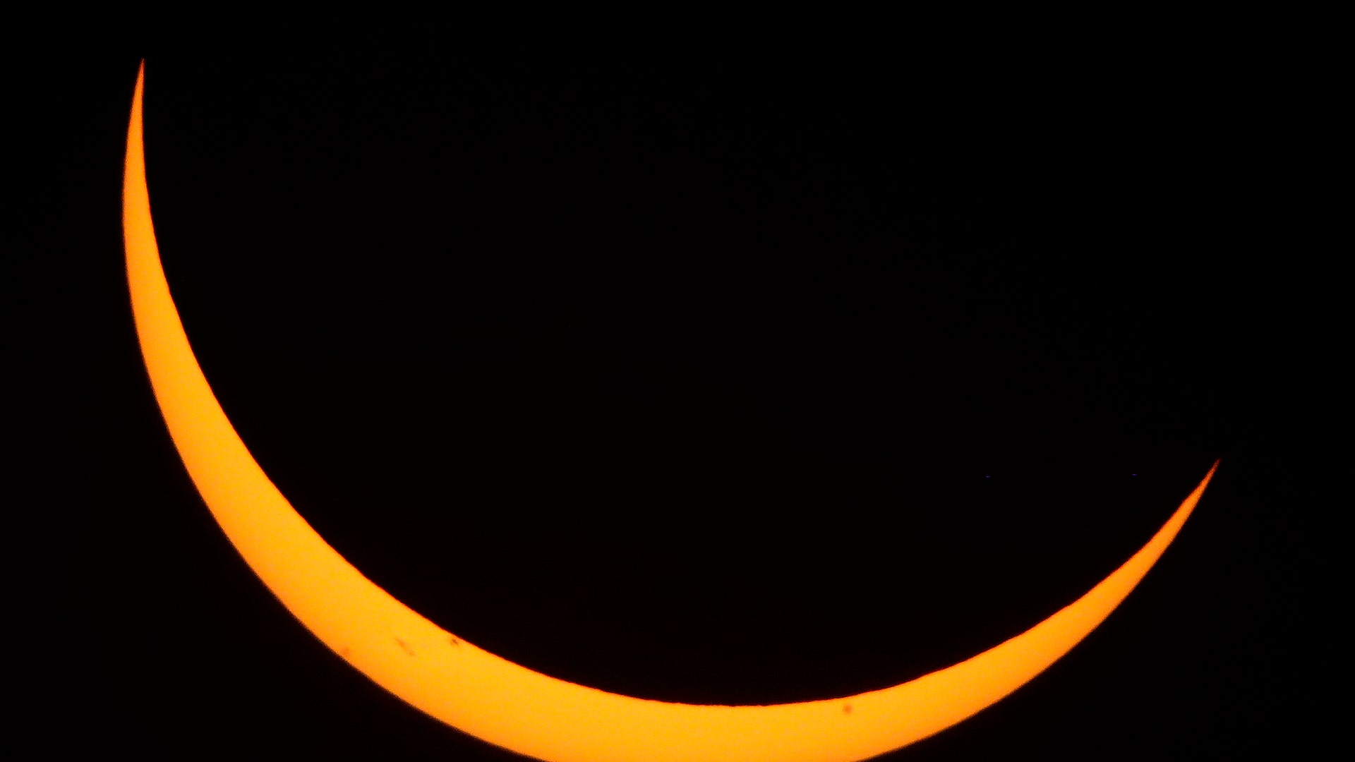 The moon passes in front of the sun during the partial phase of a total eclipse near Useful, Missouri
