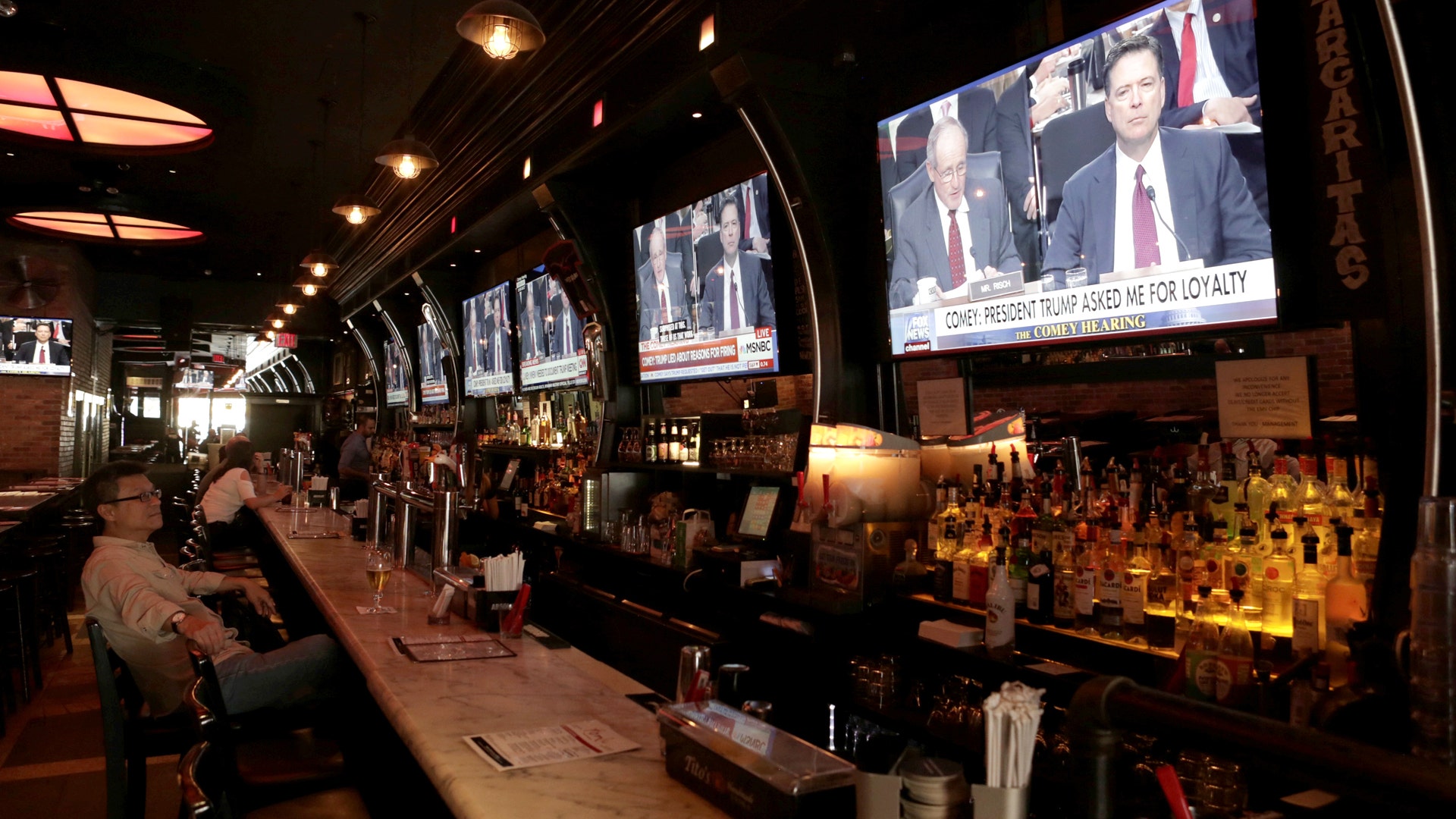 Watching former FBI director James Comey's testimony before the Senate Intelligence Committee in a bar in New York City