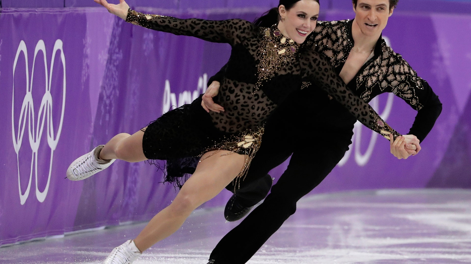 Tessa Virtue and Scott Moir of Canada perform their short program in ice dance figure skating at the 2018 Winter Olympics