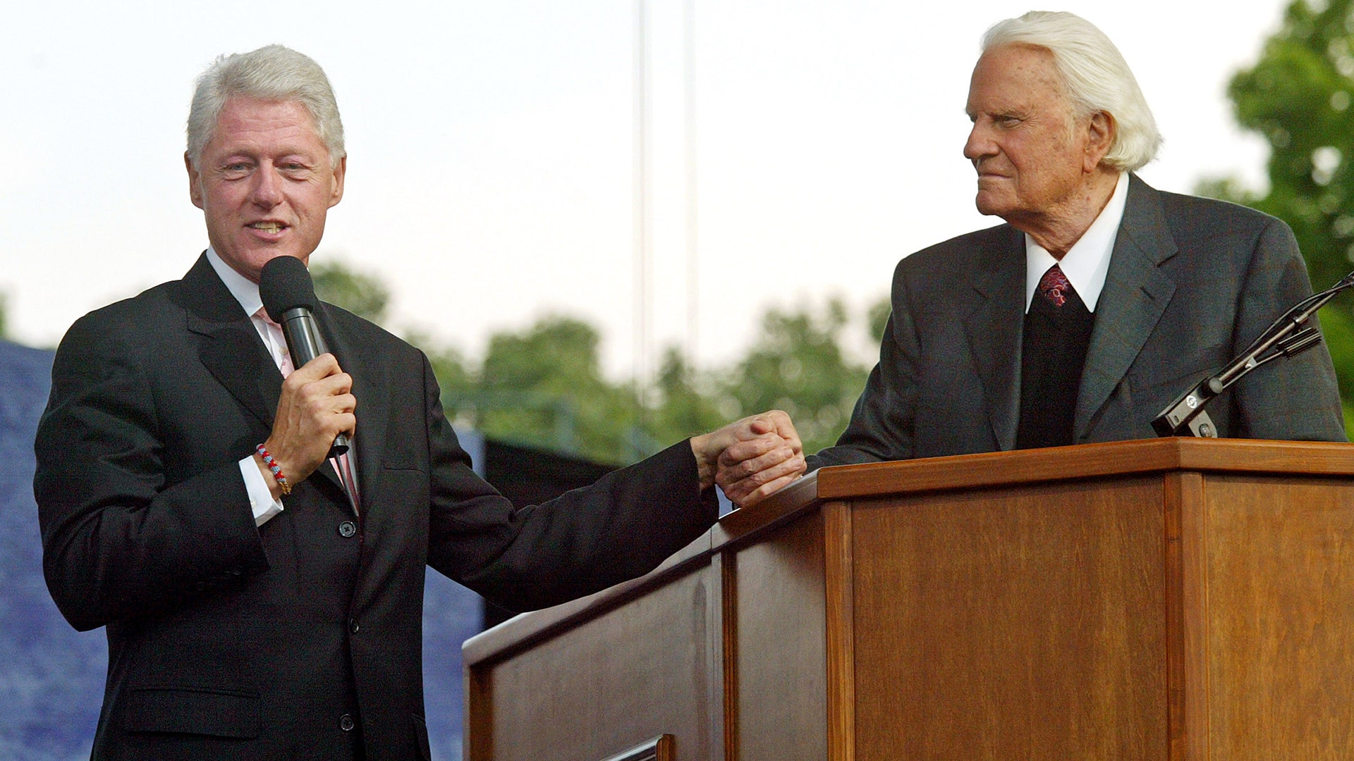 Former United States president Bill Clinton with evangelist Billy Graham at Flushing Meadows Park in New York, June 25, 2005