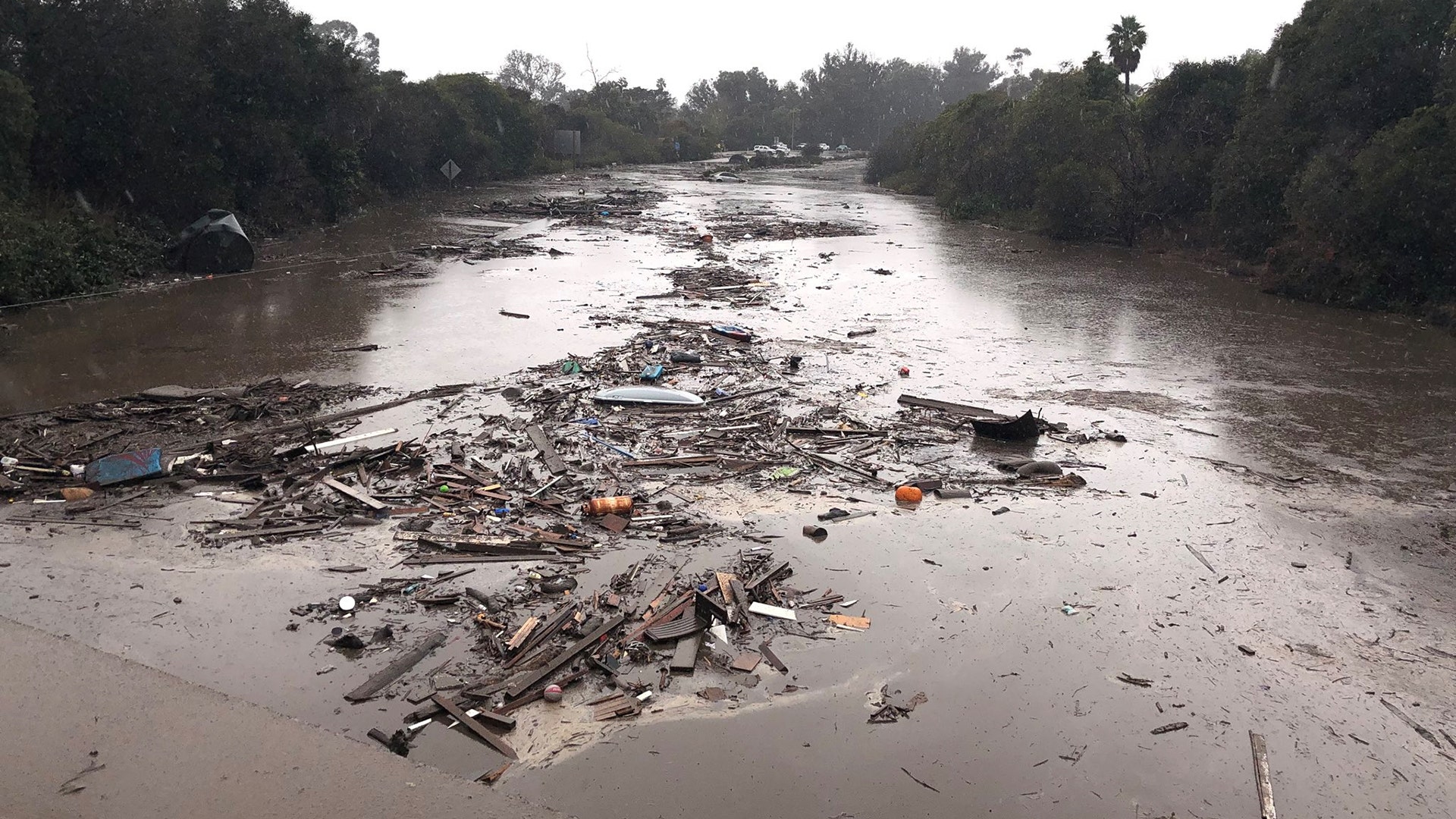 Debris floats in flooded waters on the freeway after a mudslide in Montecito, January 9, 2018
