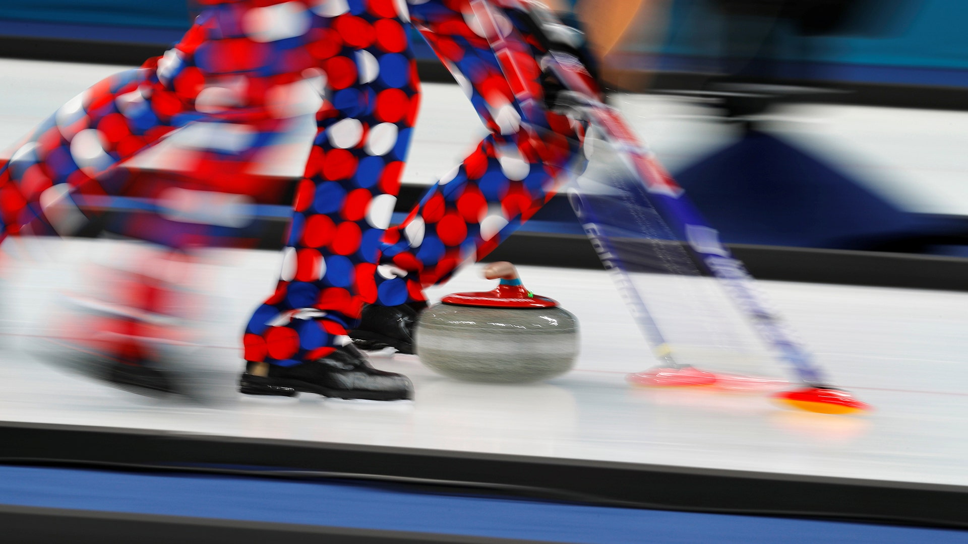 Norway's curlers sweep during a match against South Korea at the 2018 Winter Olympics