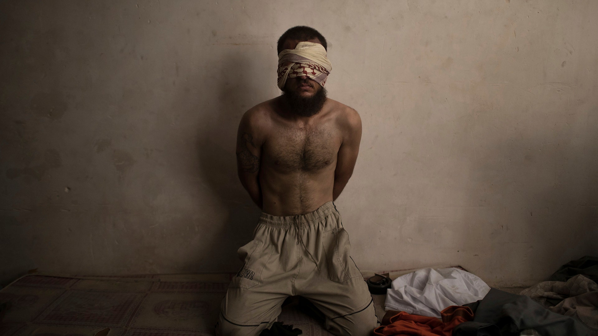 A suspected Islamic State fighter in a basement as Iraqi forces continue their advance against Islamic State militants in Mosul, Iraq, July 3, 2017