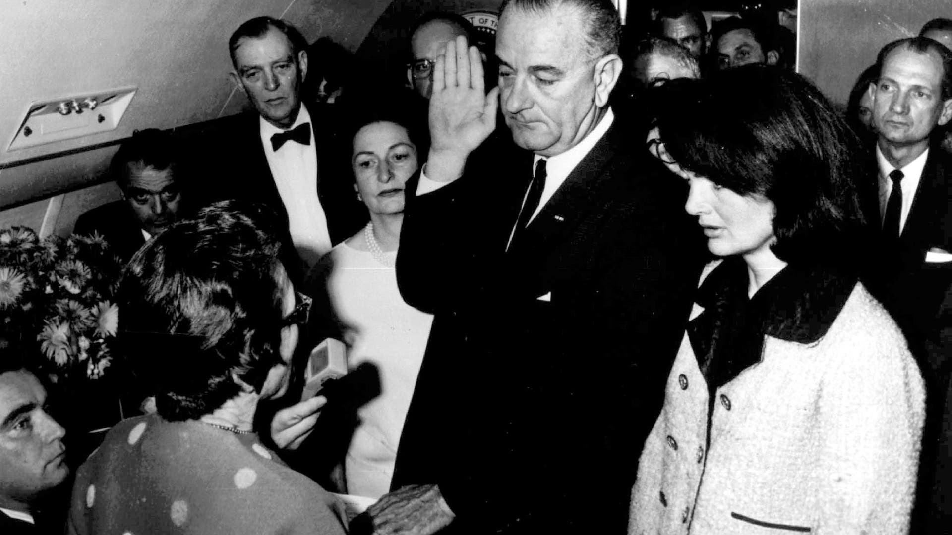 Lyndon Johnson is sworn in as US President in cabin of Air Force One after John F. Kennedy assassination, with Jacqueline Kennedy at right, on Nov. 22, 1963