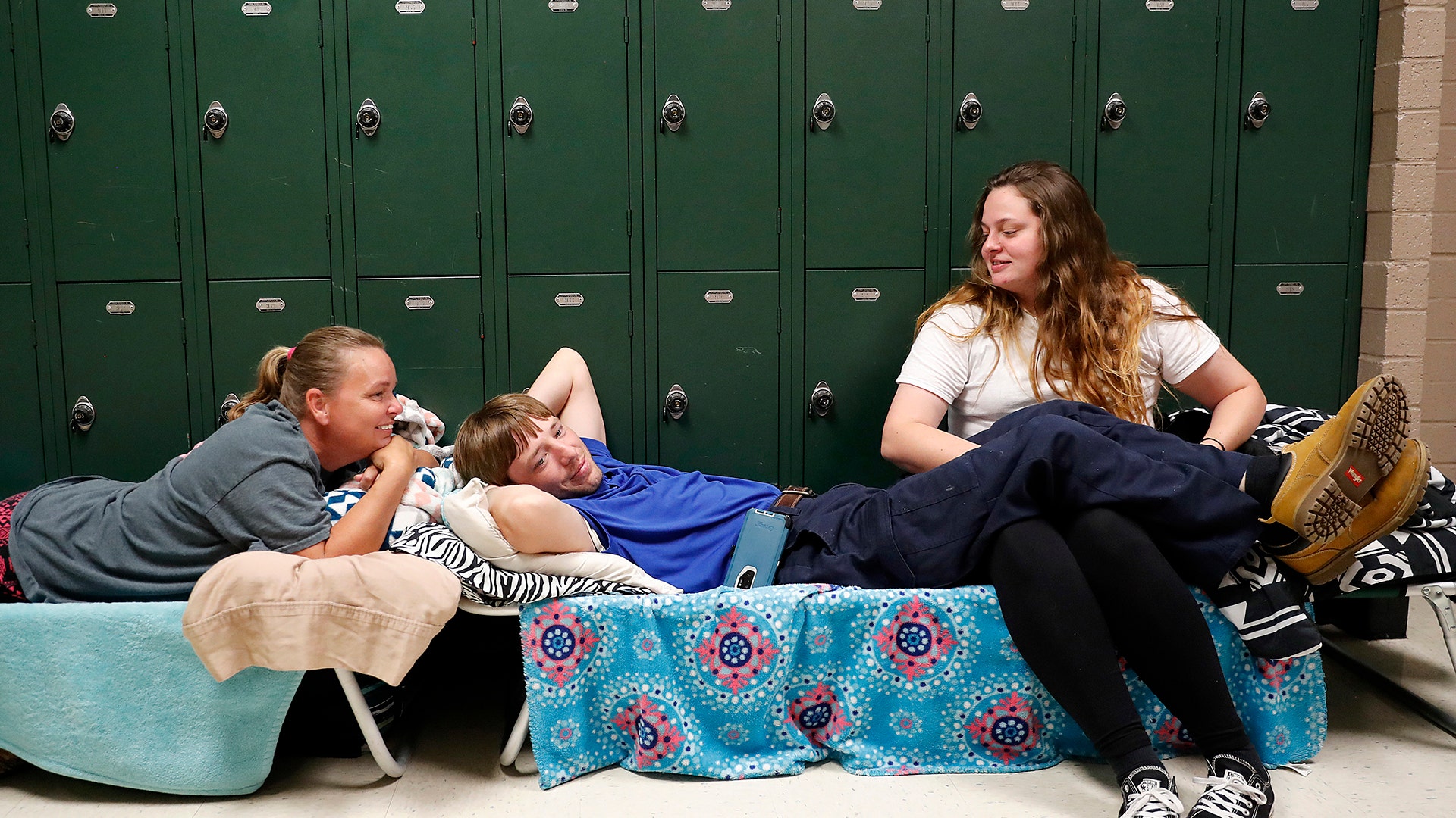 People wait in a shelter for Hurricane Florence to pass after evacuating from their nearby homes, in Conway, South Carolina, Wednesday