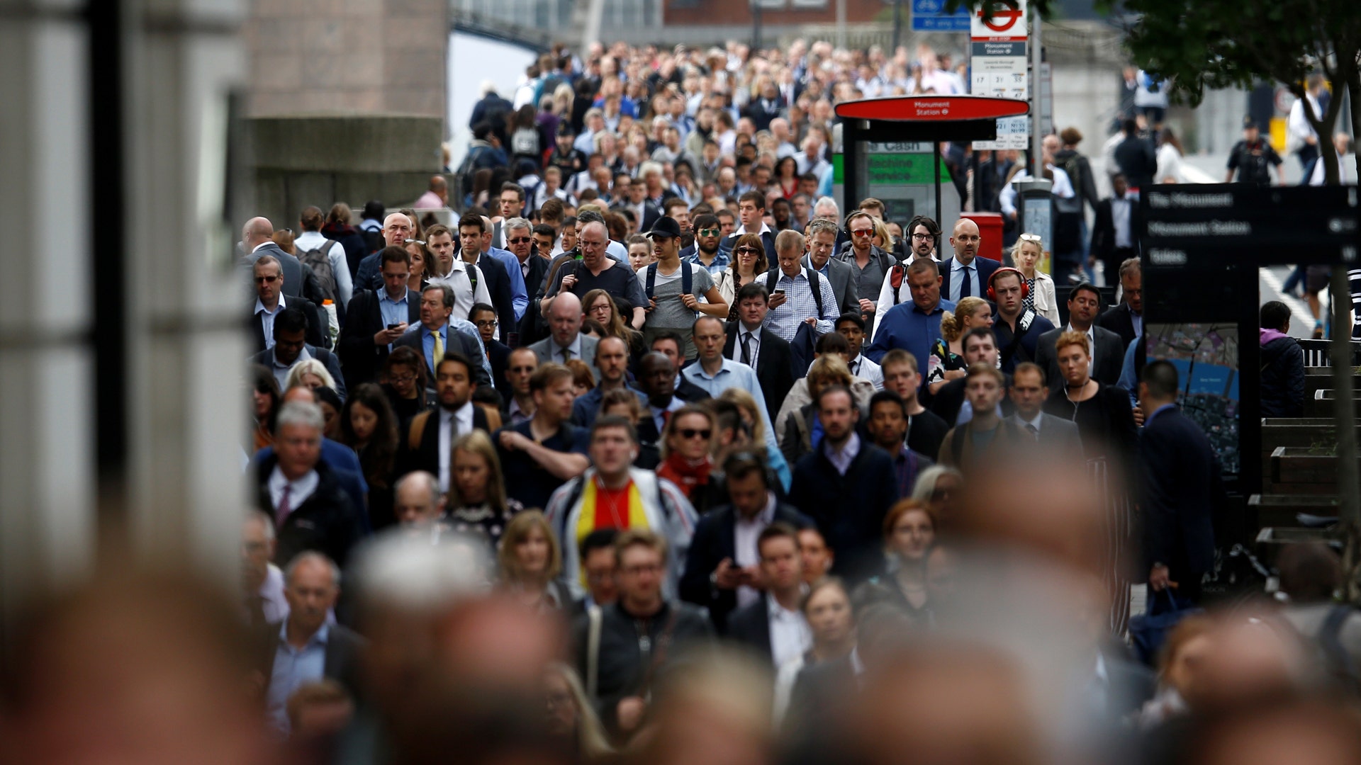Commuters walking across London Bridge