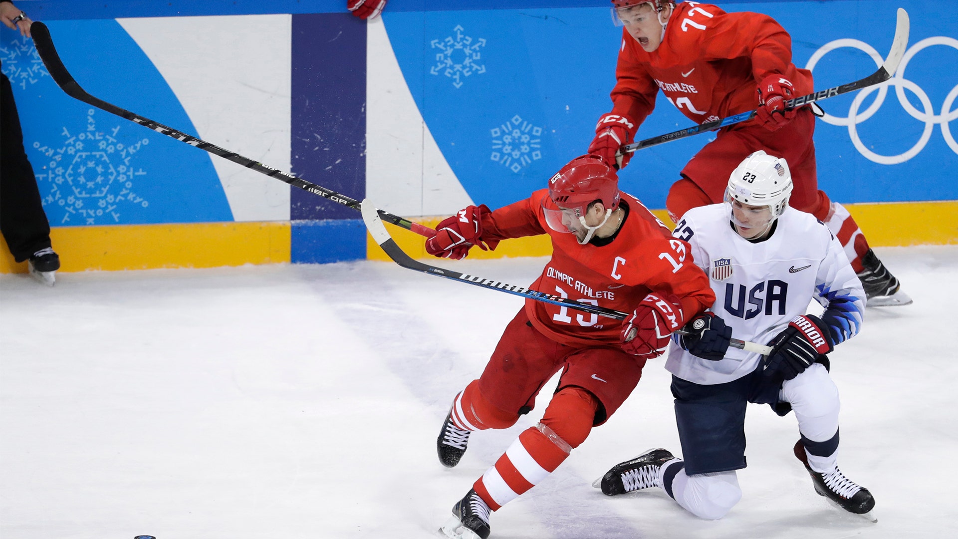 Russian athlete Pavel Datsyuk (13) battles with Troy Terry (23), of the U.S.
