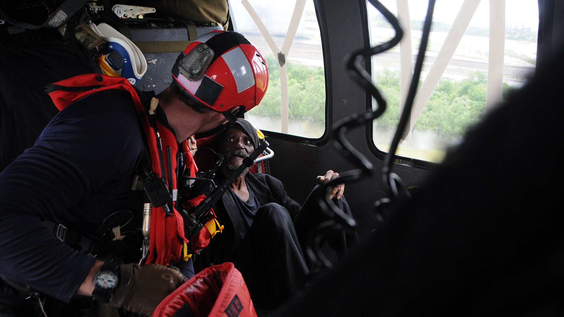 Tech. Sgt. Jordan St Clair, a pararescueman, attends to a survivor of Hurricane Harvey over Beaumont, Texas 