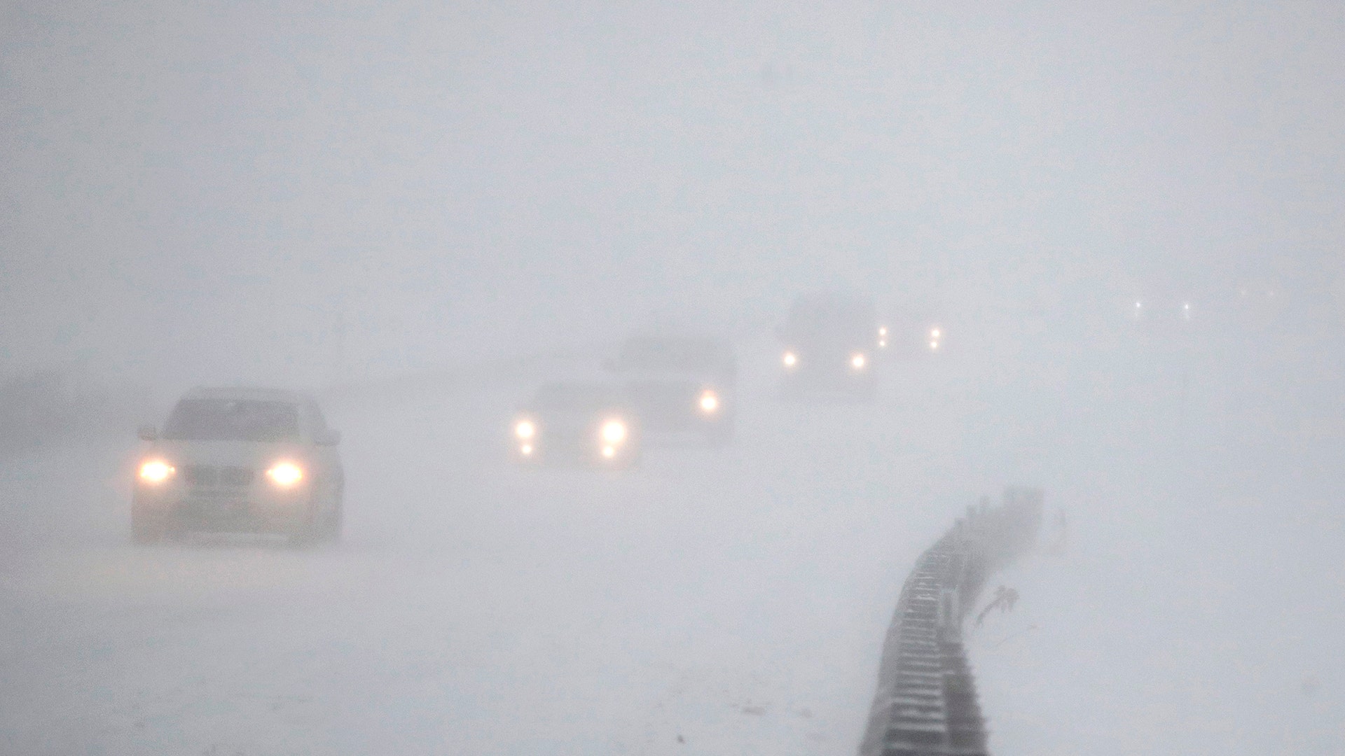 Vehicles commute southbound on the Garden State Parkway in whiteout conditions during a snowstorm, in Eatontown, N.J., Thursday