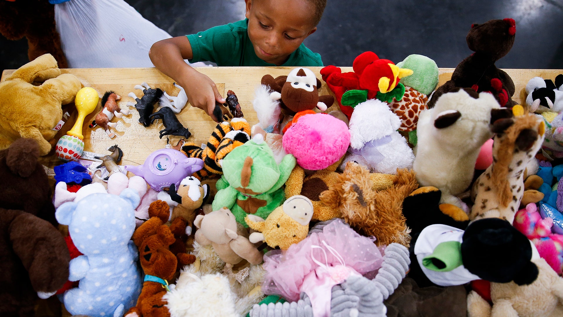 Jacob Evans, 4, picks out a toy at the George R. Brown Convention Center, Wednesday, in Houston
