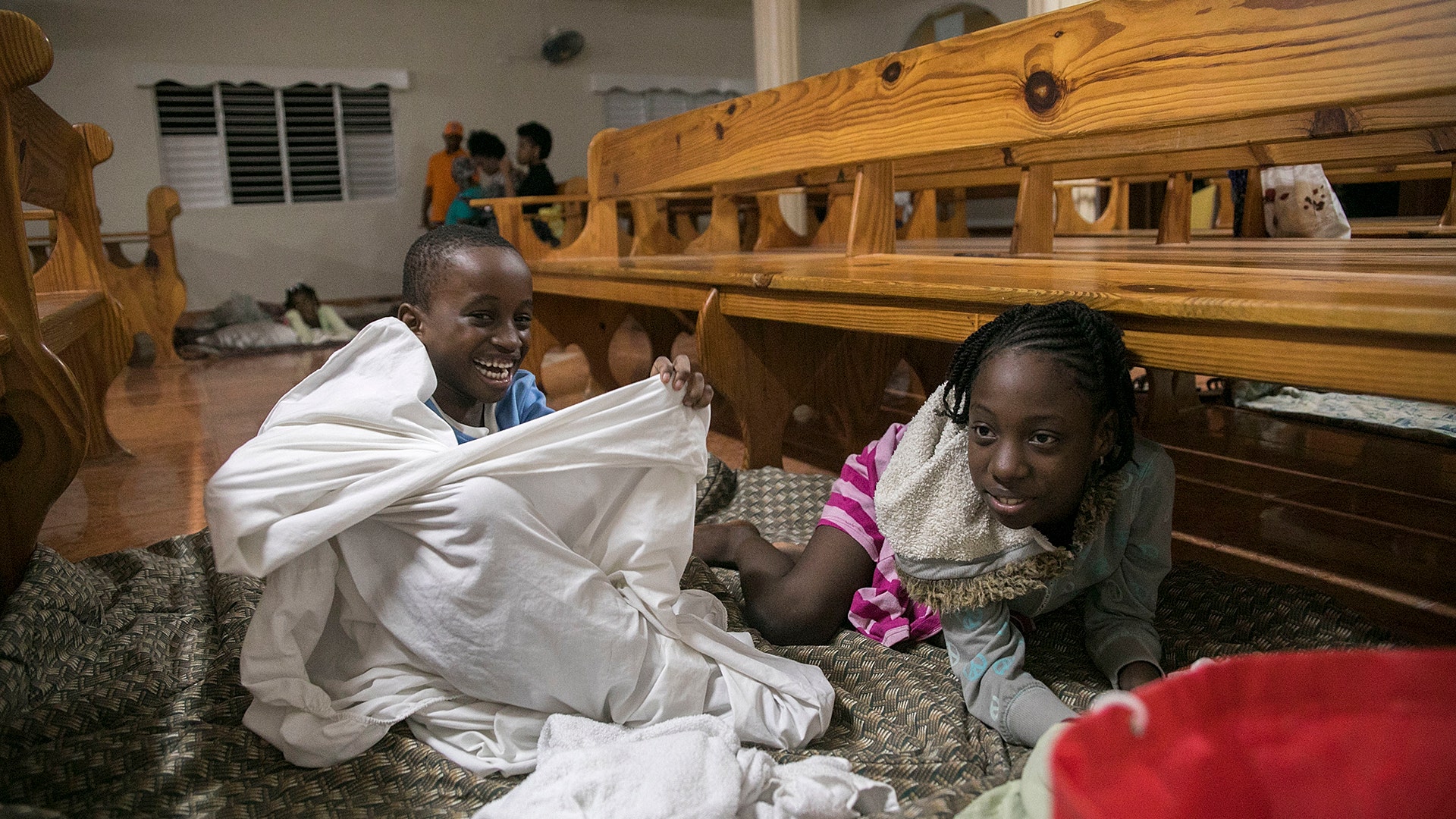Kids play at a shelter in a local church during the evening before the arrival of Hurricane Irma in Las Terrenas, Dominican Republic, Wednesday
