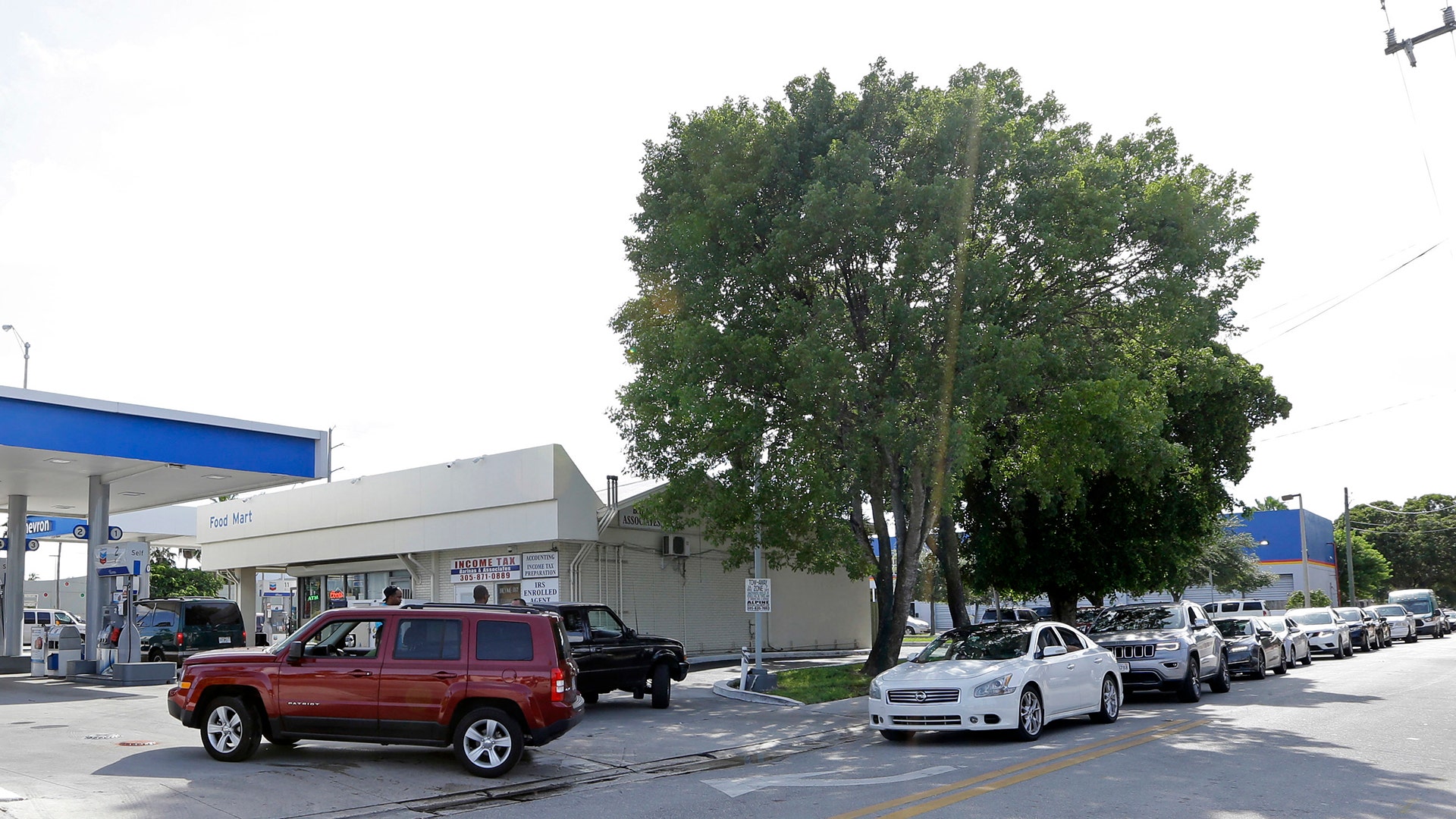 Motorists line up for gas in Miami, Thursday