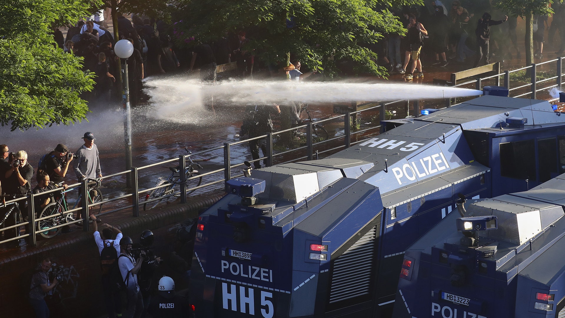 German riot police use water cannons against protesters during demonstrations at the G-20 summit in Hamburg, Germany