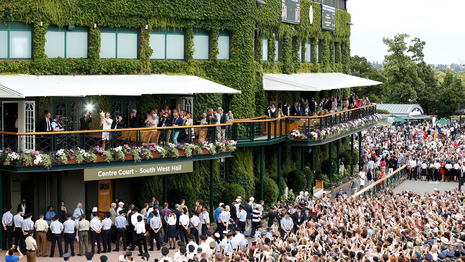 Switzerland’s Roger Federer with the trophy on the balcony outside center court after winning the final against Croatia’s  Marin Cilic
