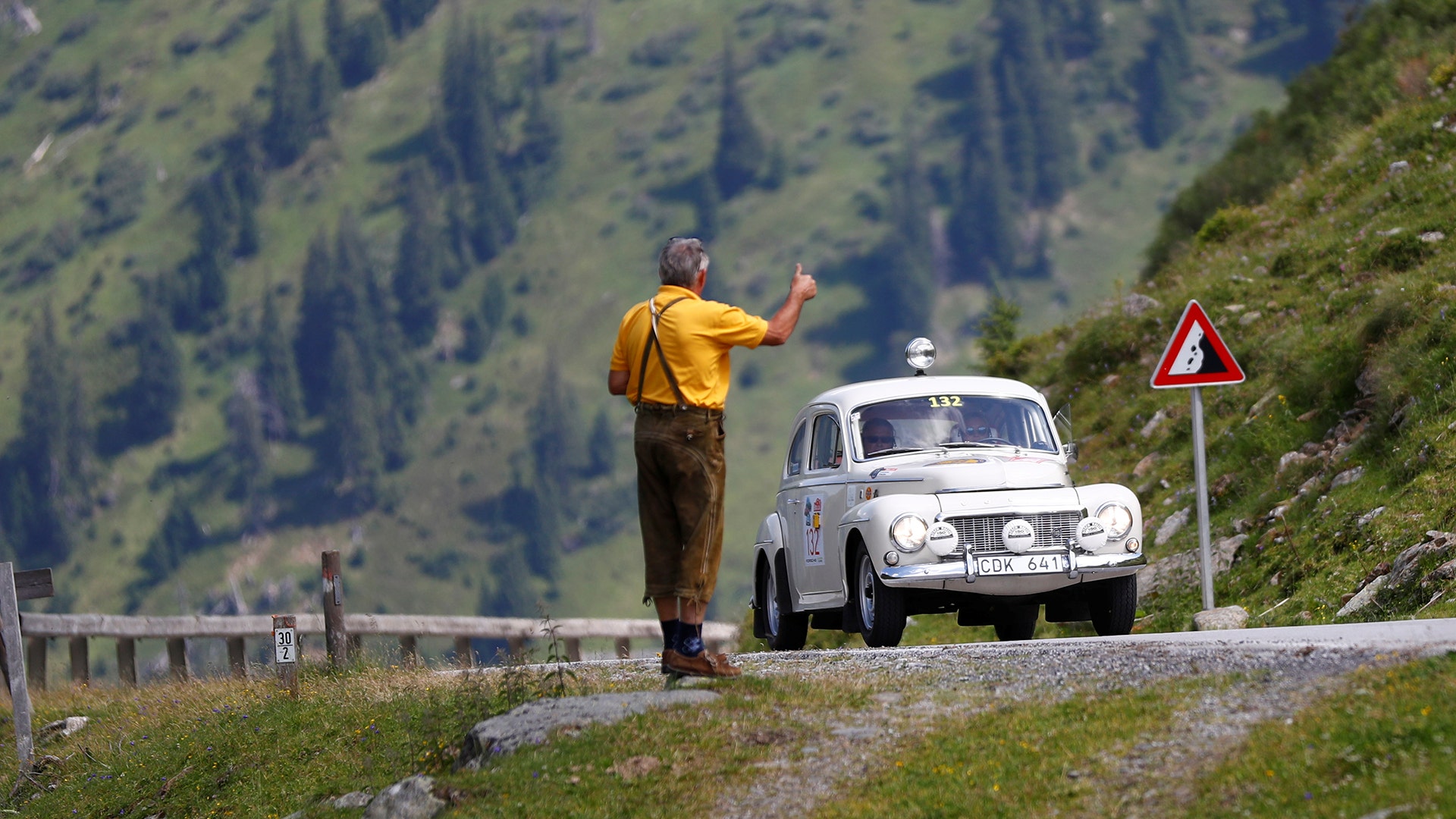 Looking for a ride during the Ennstal classic old-timer rally on the road to Soelkpass, Austria