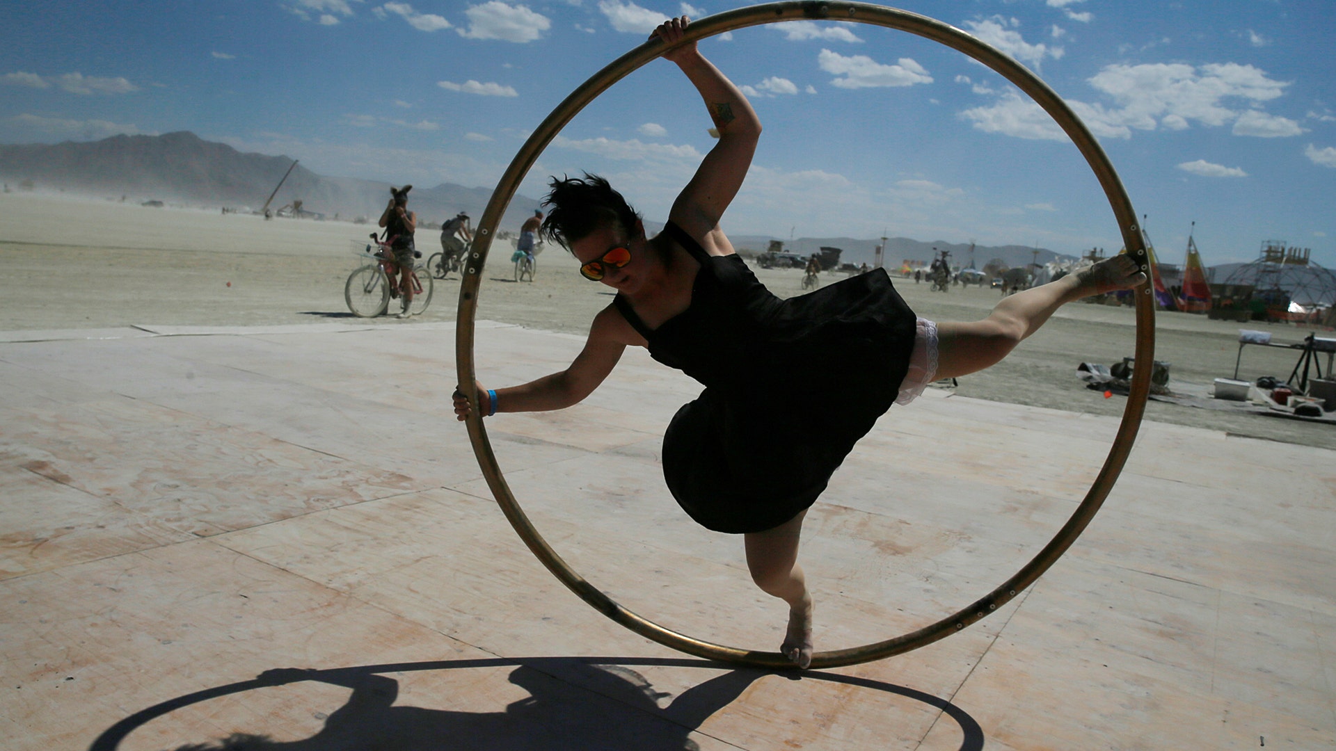 Kylie Webb of Santa Cruz, California spins inside a metal hoop on a roller disco floor at the Burning Man arts and music festival, August 28 
