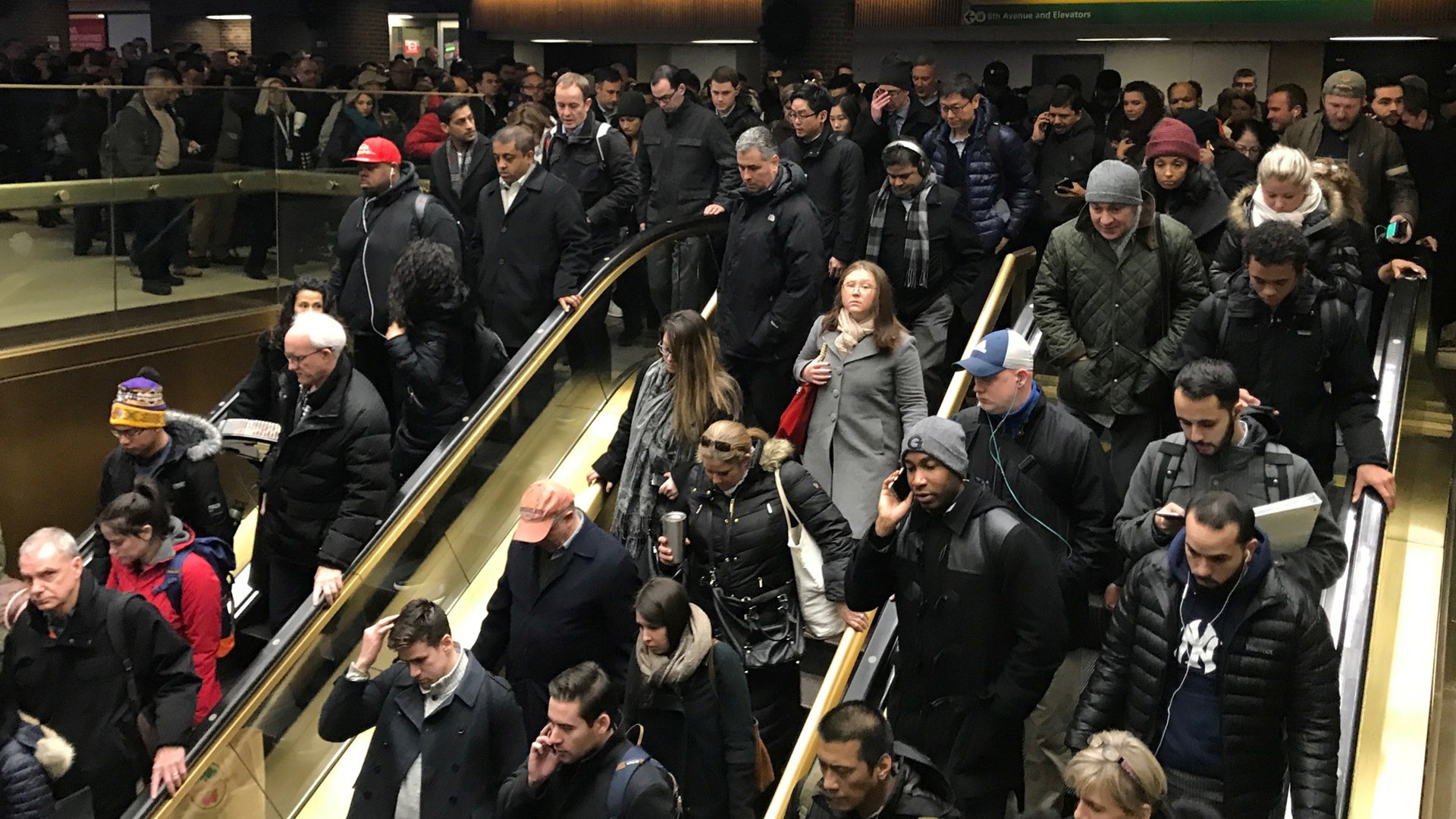 Commuters leave the New York Port Authority Bus Terminal in New York City after an explosion, Monday