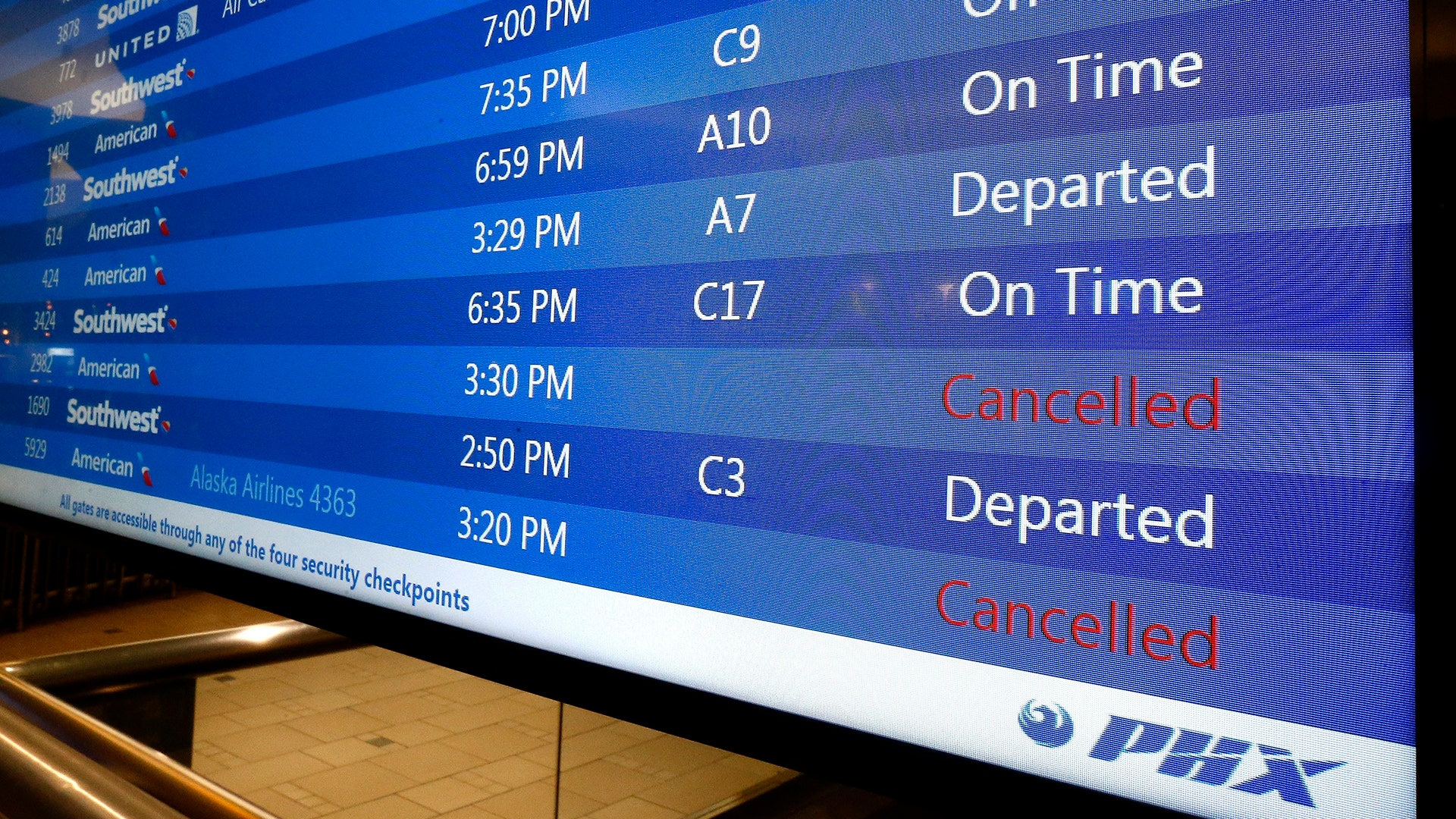 A departure sign at Sky Harbor International Airport shows regional jet cancellations because of a heat wave in Phoenix, Tuesday,